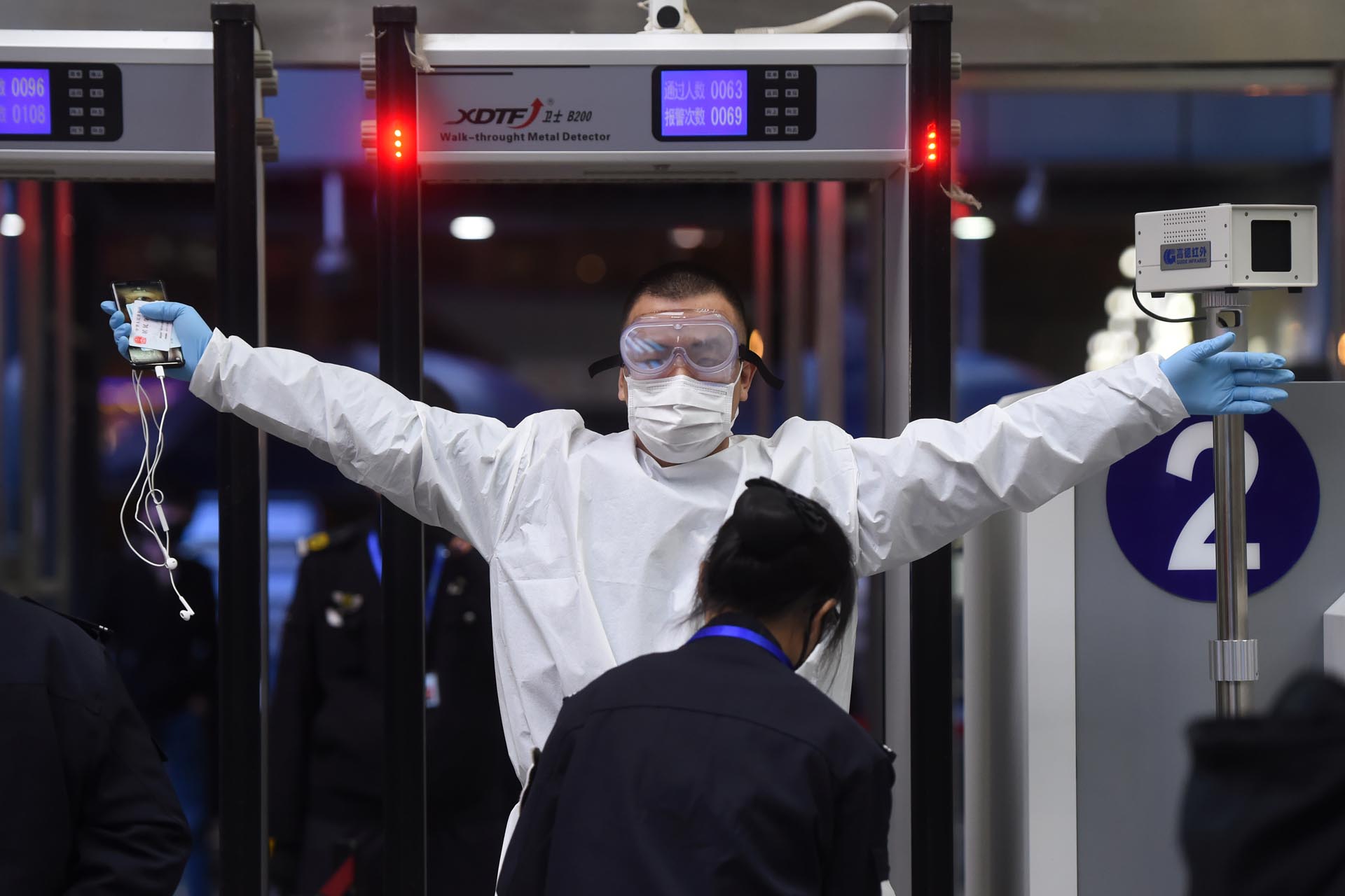 A man wearing protective gear gets through security check at Wuchang Railway Station before travel restrictions to leave Wuhan, the capital of Hubei province and China's epicentre of the novel coronavirus disease (COVID-19) outbreak, are lifted, April 7, 2020. Picture taken April 7, 2020. REUTERS