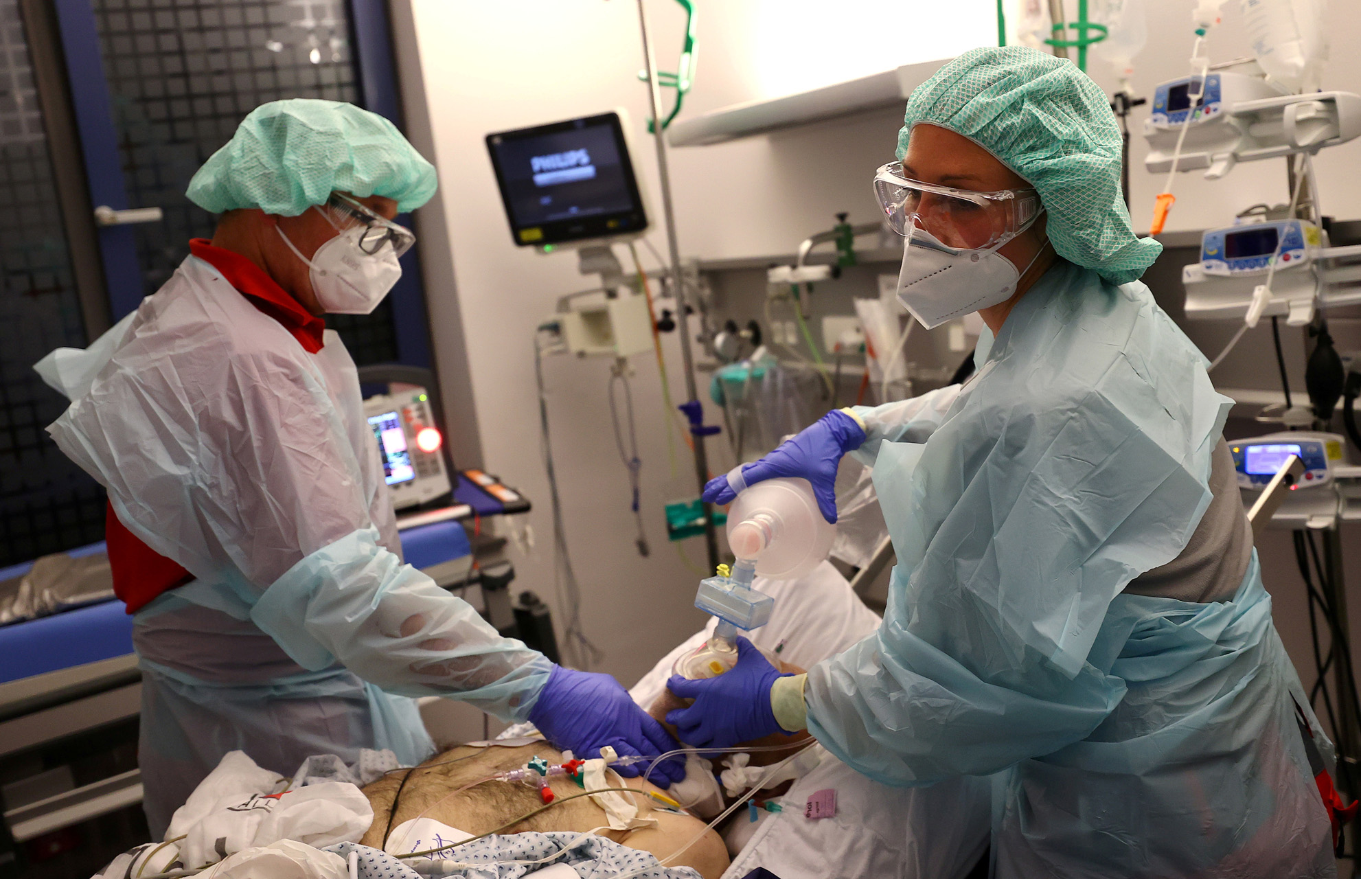 Doctor Katharina Franz and paramedic Andreas Hankel, of the rescue helicopter "Christoph Giessen", take care of a patient during preparations for his transport in the special isolation chamber "IsoArk", for highly infectious coronavirus disease (COVID-19) patients, from a clinic in Hanau, Germany, April 16, 2020, as the spread of the coronavirus disease (COVID-19) continues. REUTERS