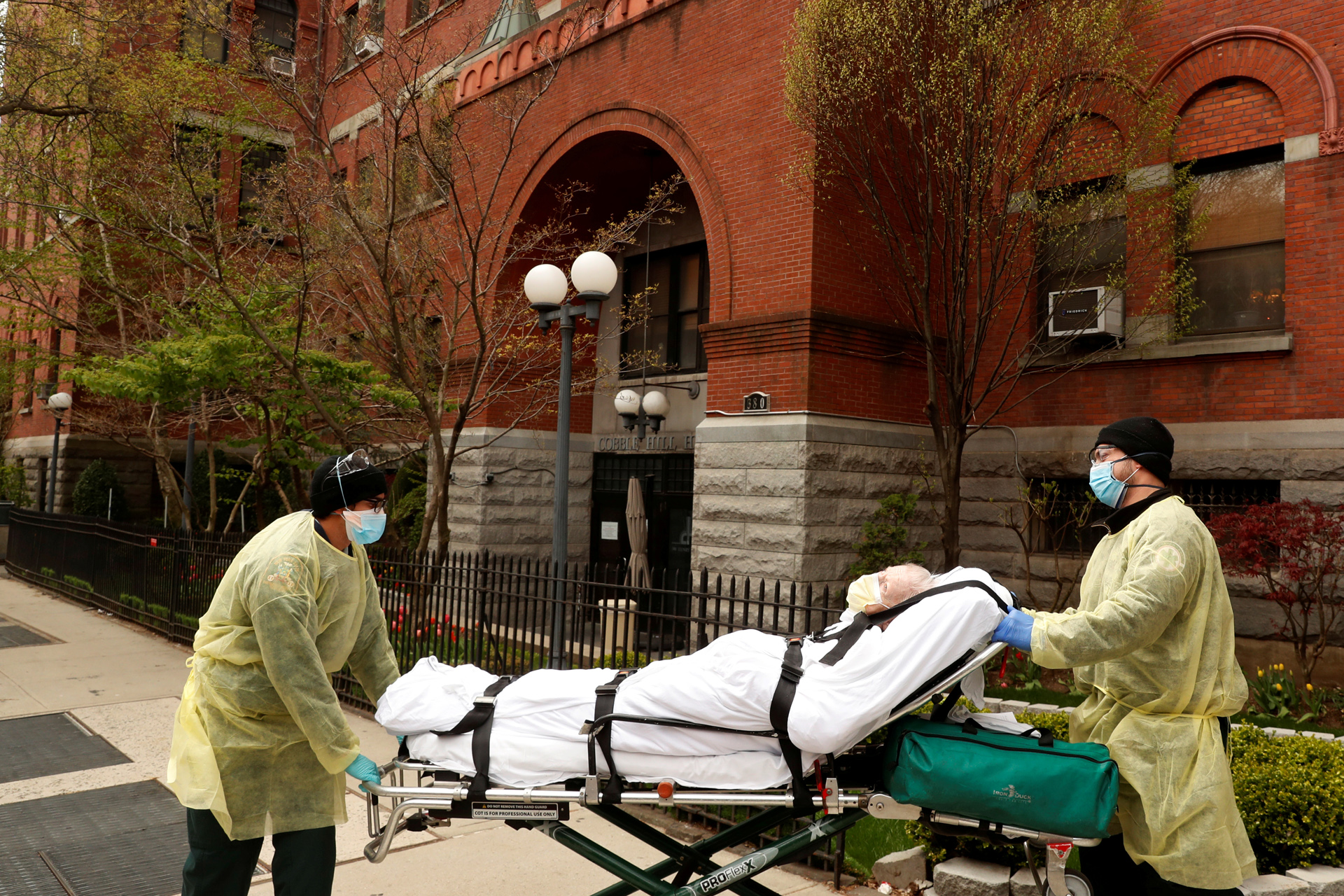 Emergency Medical Technicians (EMTs) wheel a man out of the Cobble Hill Health Center nursing home during an ongoing outbreak of the coronavirus disease (COVID-19) in the Brooklyn borough of New York, U.S., April 17, 2020. REUTERS
