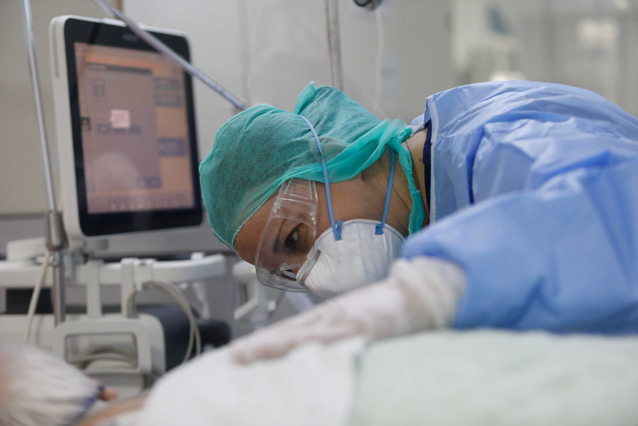 A medical worker checks on a patient at the intensive care unit (ICU) of the Sotiria hospital, following the coronavirus disease (COVID-19) outbreak, in Athens, Greece, April 22, 2020. REUTERS