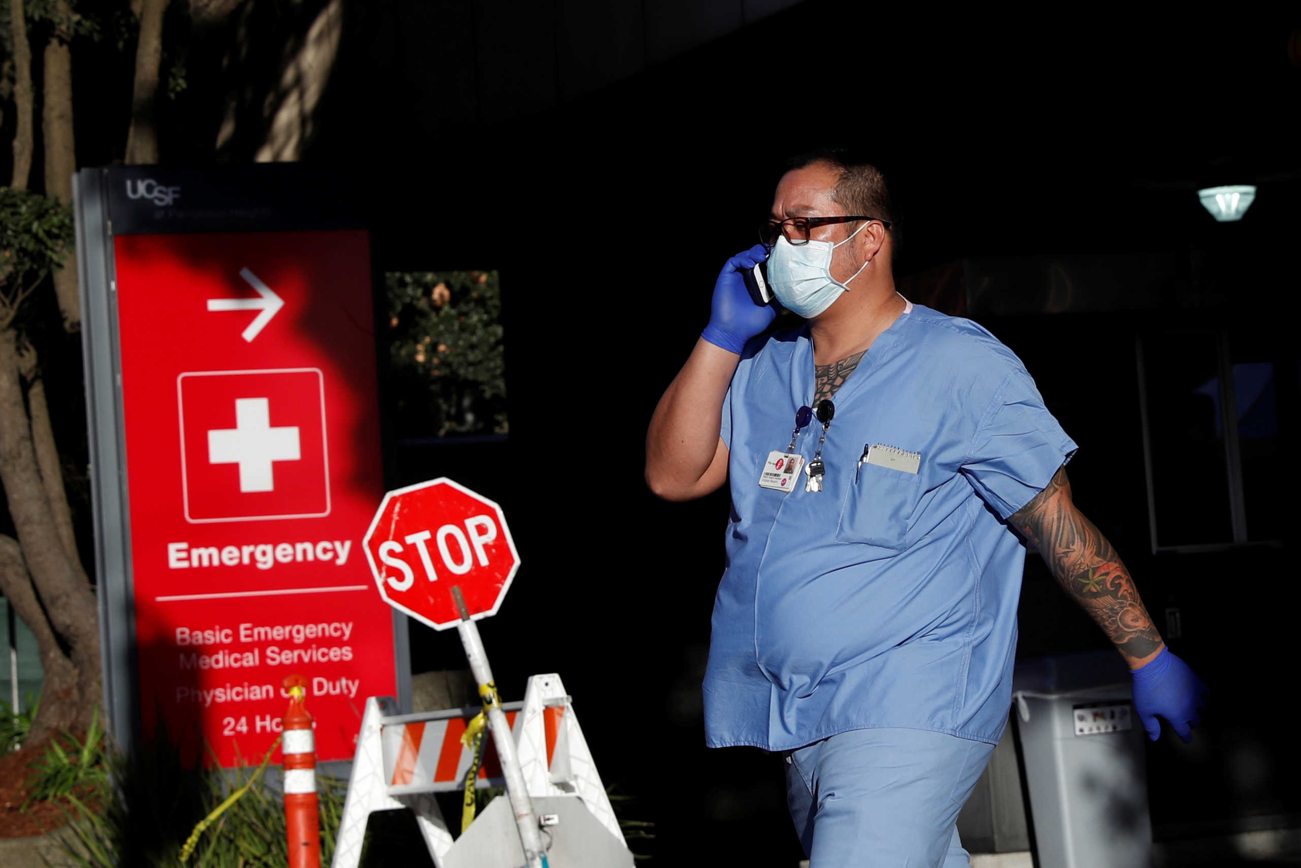 A hospital worker walks out of a garage amid an outbreak of the coronavirus disease (COVID-19), at the University of California San Francisco Parnassus campus in San Francisco, California, U.S., April 1, 2020. REUTERS