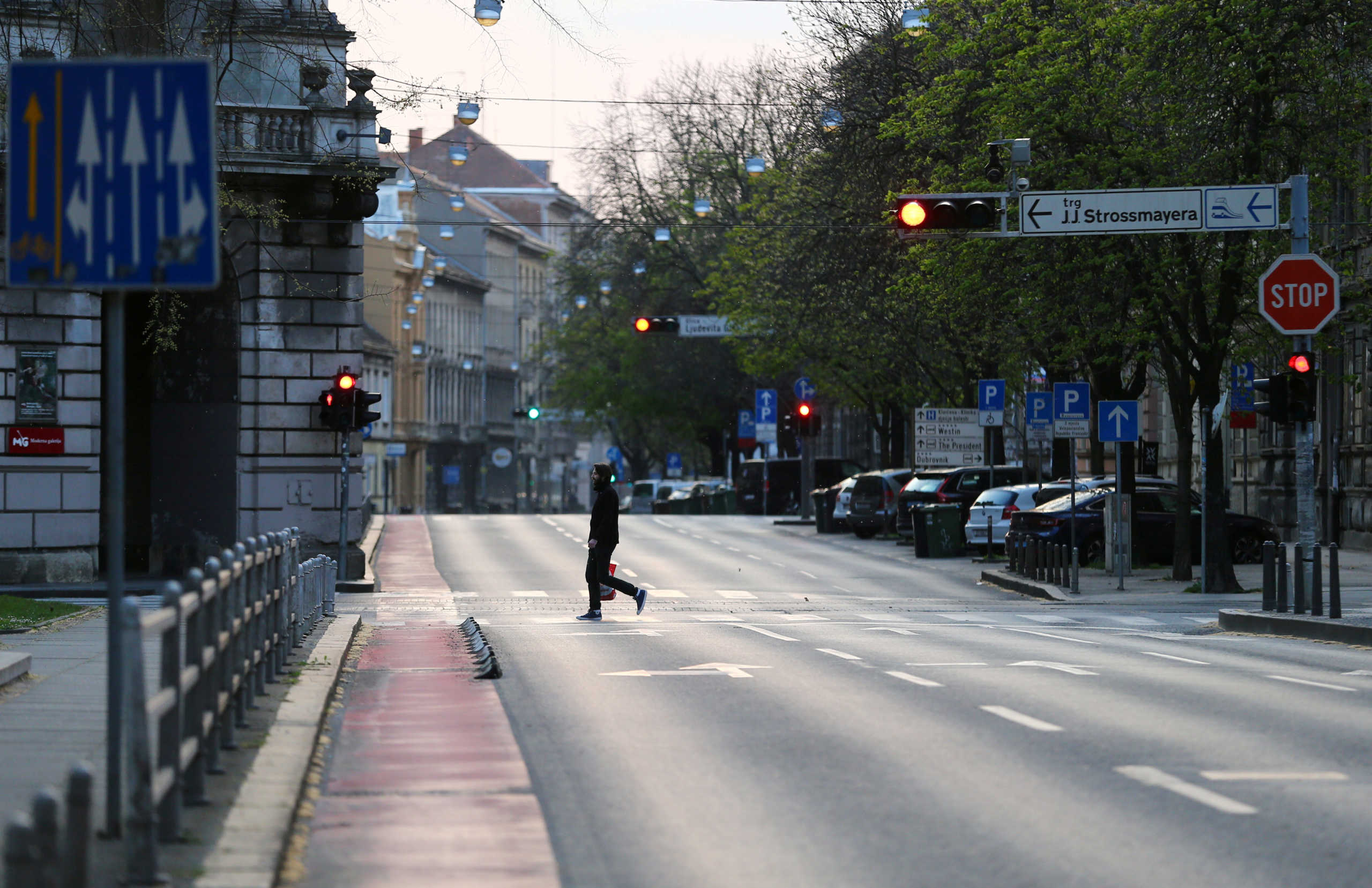 FILE PHOTO: A man crossing a street as Croatia is stepping up measures to fight the coronavirus disease (COVID-19) outbreak, in Zagreb, Croatia March 21, 2020. REUTERS