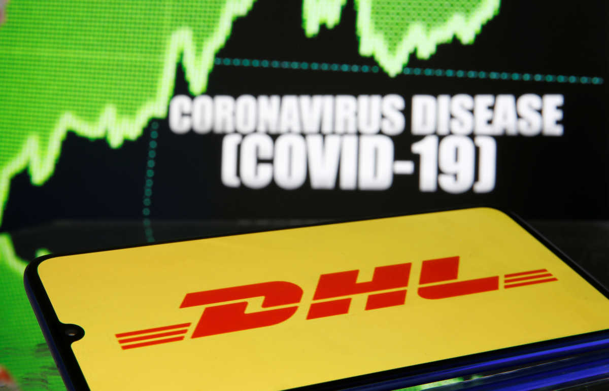DHL logo is seen in front of diplayed coronavirus disease (COVID-19) in this illustration taken March 19, 2020. REUTERS