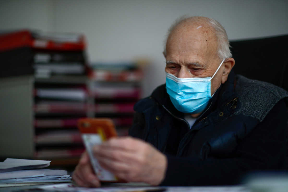 French doctor Christian Chenay, 98 year-old, wearing a protective face mask, sits in his consulting room at the doctor's office in Chevilly-Larue near Paris as the spread of the coronavirus disease (COVID-19) continues in France April 14, 2020. Picture taken April 14, 2020. REUTERS