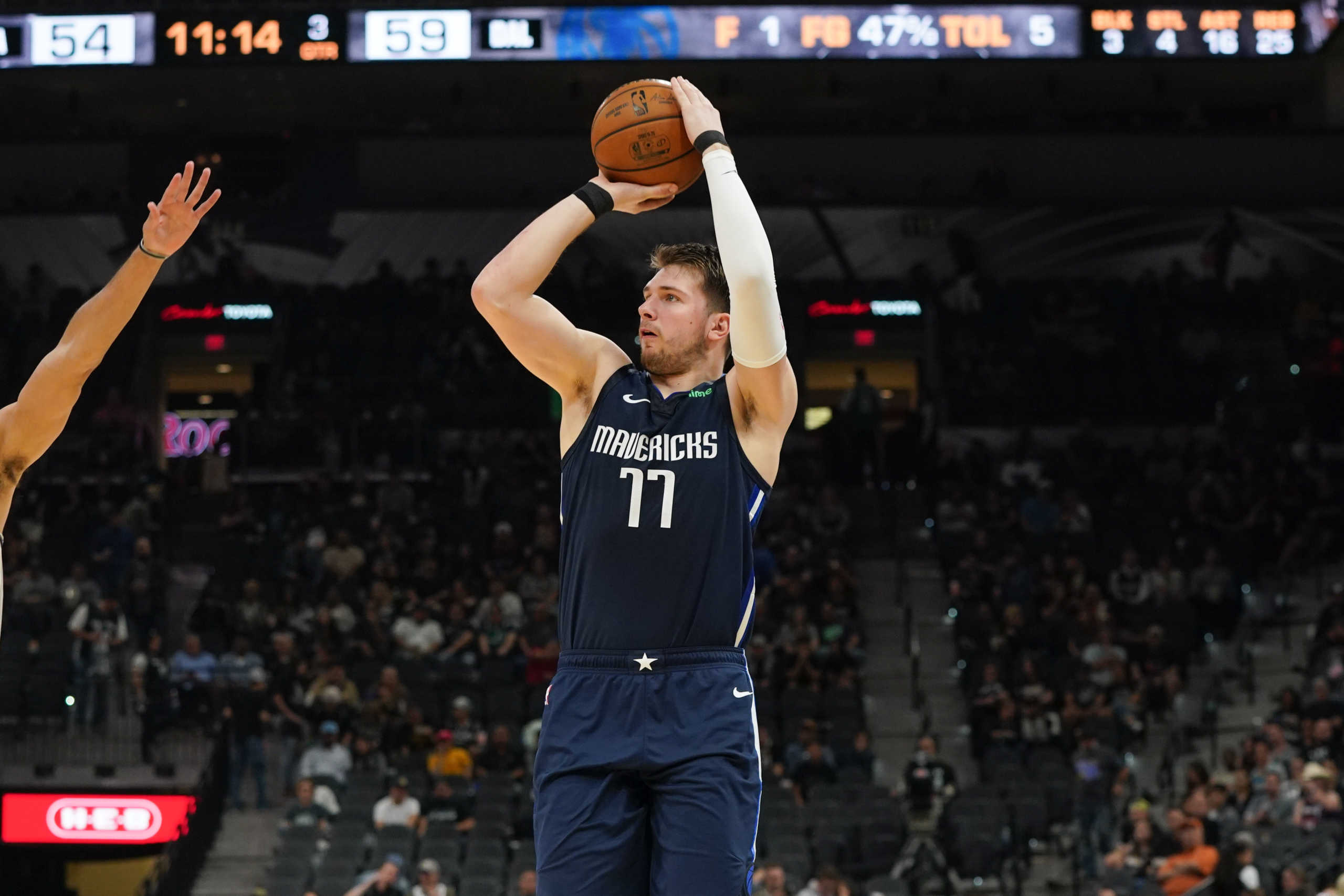 Mar 10, 2020; San Antonio, Texas, USA;  Dallas Mavericks guard Luka Doncic (77) shoots against the San Antonio Spurs in the second half at the AT&T Center. Mandatory Credit: Daniel Dunn-USA TODAY Sports
