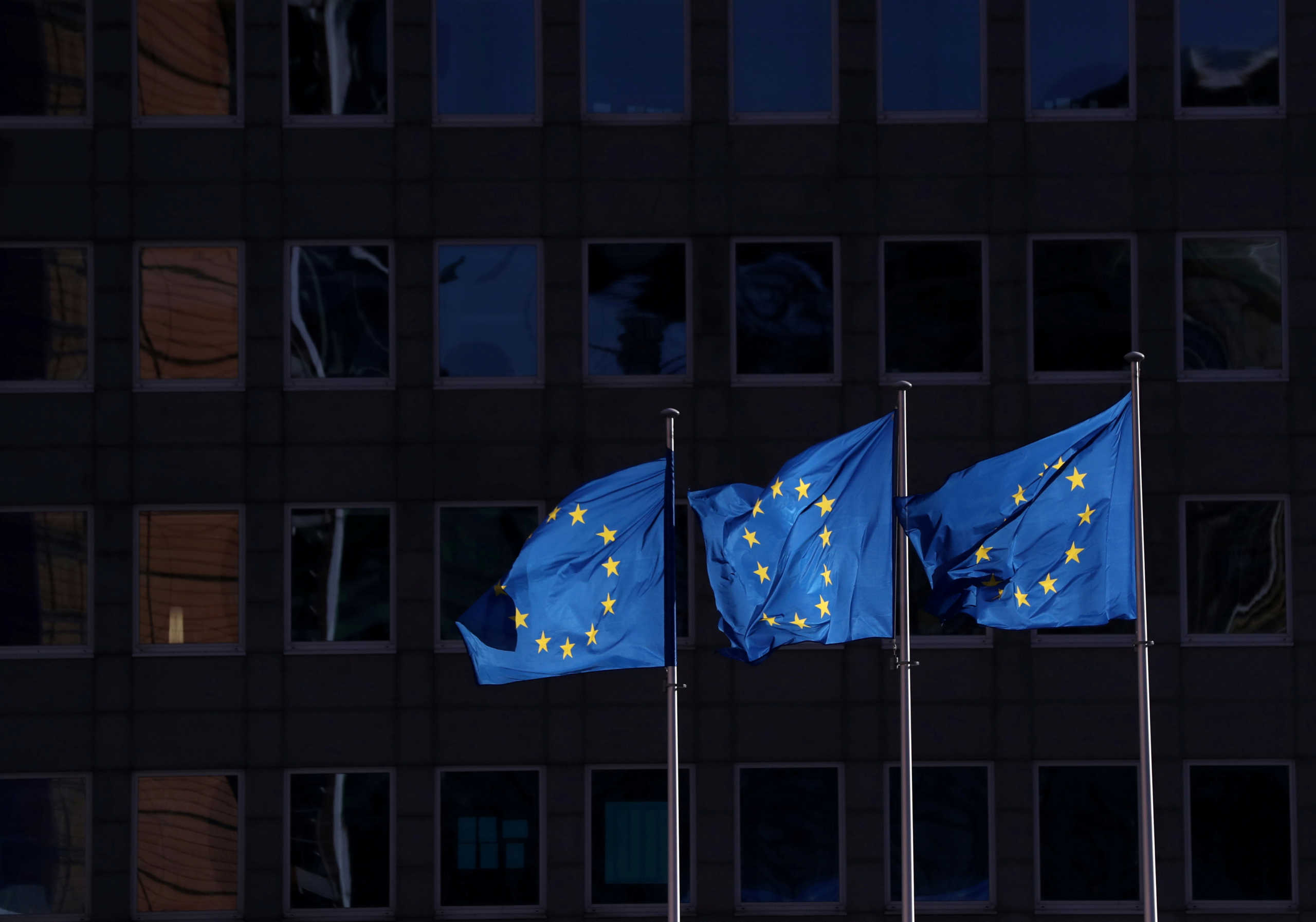 FILE PHOTO: European Union flags fly outside the European Commission headquarters in Brussels, Belgium, February 19, 2020. REUTERS