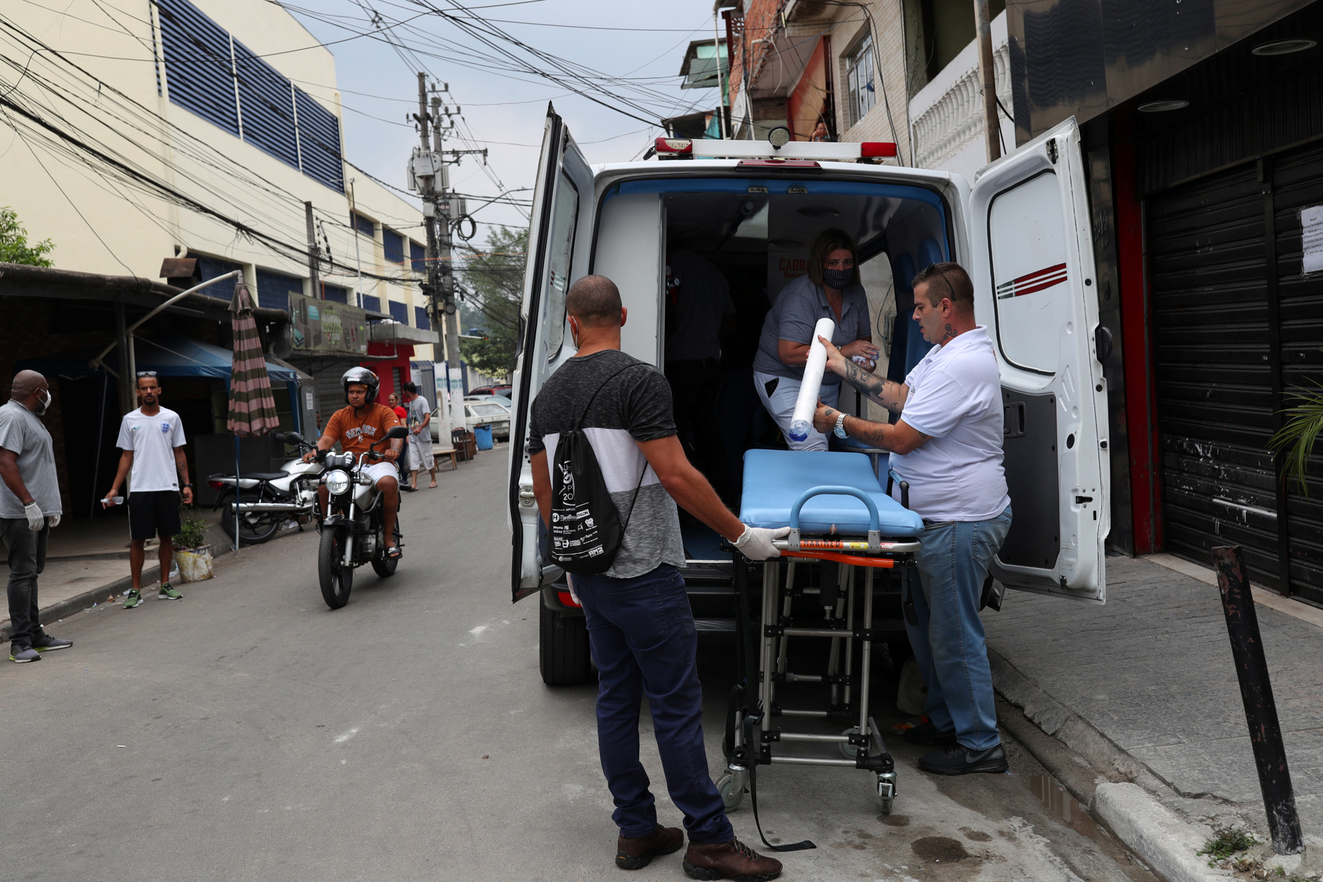 Medical personnel prepare an ambulance after residents of the city's biggest slum Paraisopolis have hired a round-the-clock private medical service to fight the coronavirus disease (COVID-19), in Sao Paulo, Brazil March 29, 2020. Picture taken March 29, 2020. REUTERS