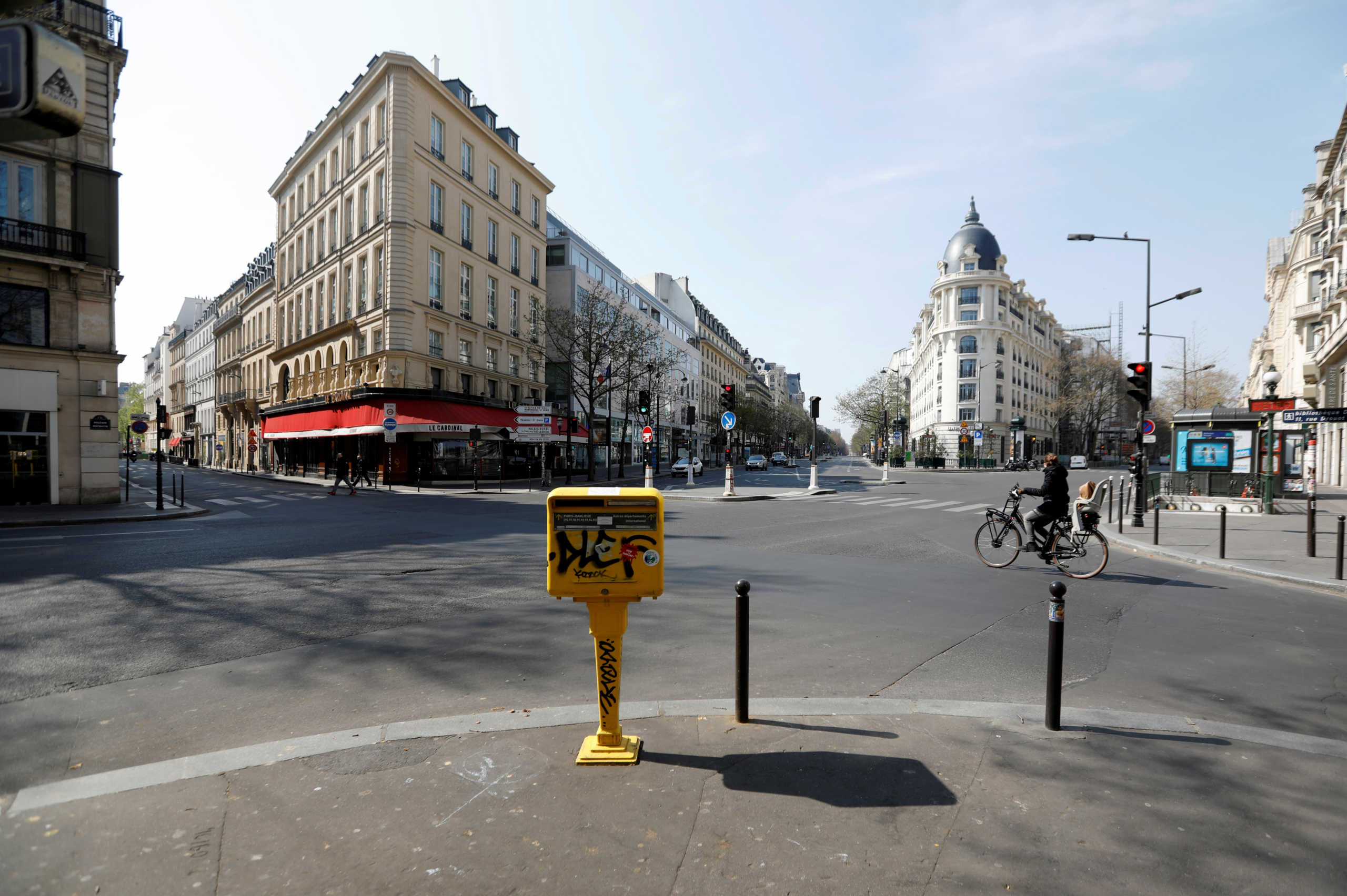 FILE PHOTO: A cyclist rides on the deserted Grands Boulevards in Paris as a lockdown is imposed to slow the rate of the coronavirus disease (COVID-19) in France, March 27, 2020. REUTERS