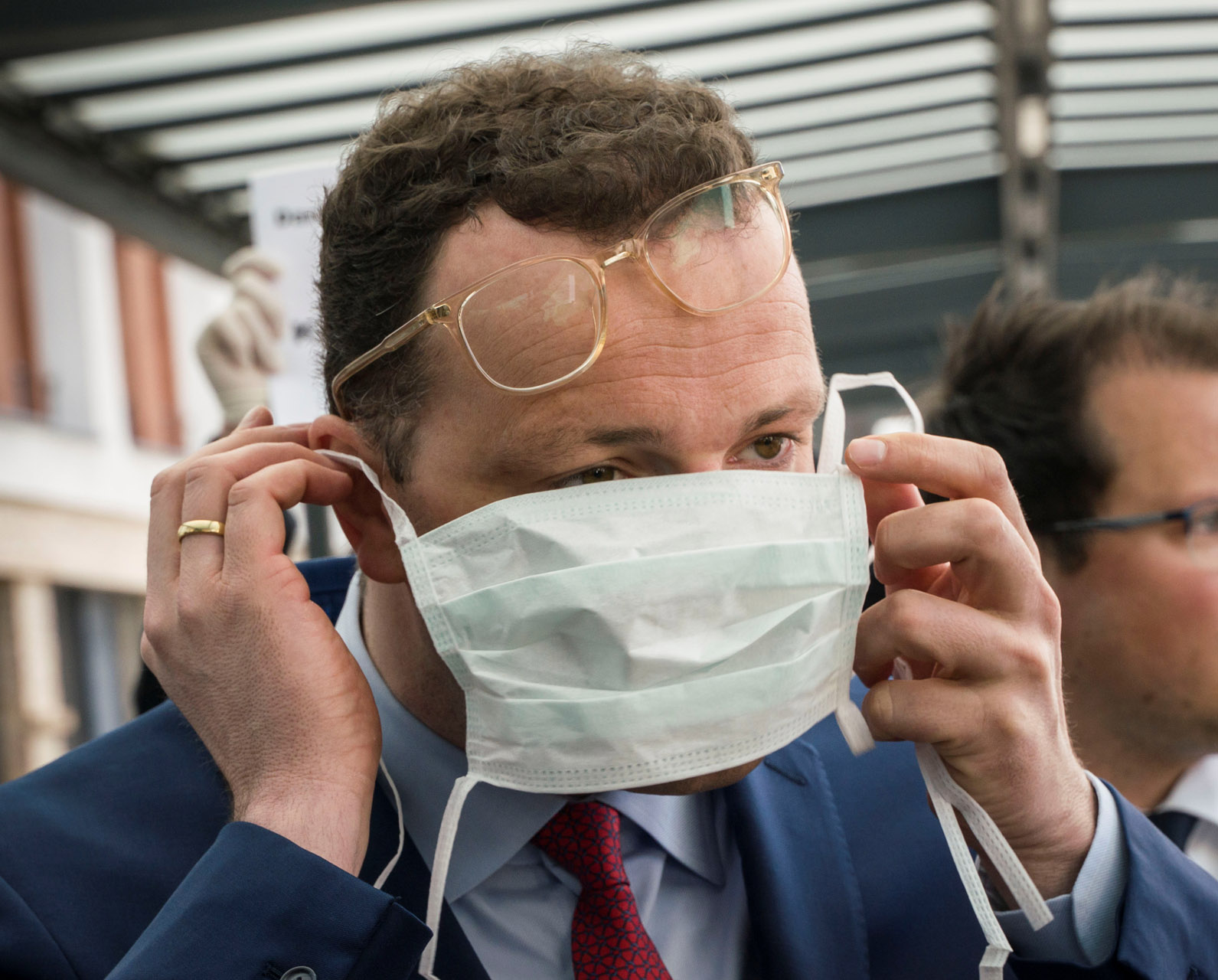 German Health Minister Jens Spahn adjusts a protective mask before visiting the the University Hospital of Giessen and Marburg in Giessen, Germany, - 14.04.2020, as the spread of the coronavirus disease (COVID-19) continues.      Frank Rumpenhorst