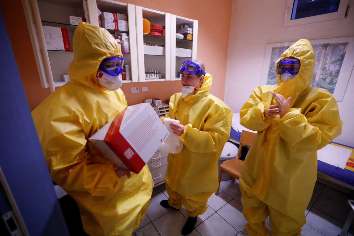 A medical staff of a general practitioners prepare equipment before they walk to a coronavirus disease (COVID-19) test center set up outside a doctor's office in a tent at Berlin's Reinickendorf district, Germany, March 23, 2020.   REUTERS