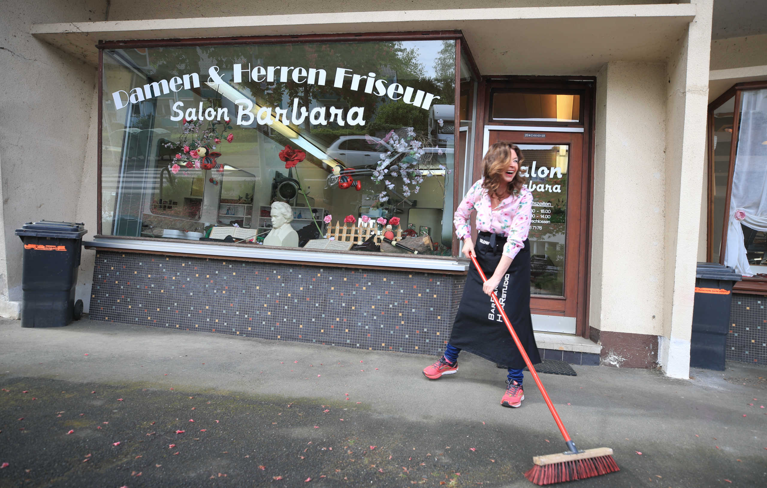 Hairdresser Barbara Hoppe prepares her shop for the reopening next week, as the spread of coronavirus disease (COVID-19) continues in Bonn, Germany, April 30, 2020. REUTERS