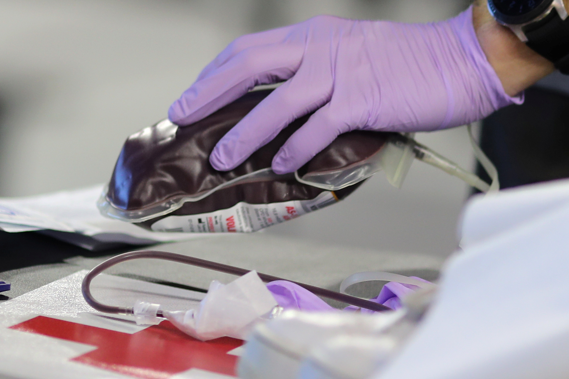 A Red Cross worker picks up donated blood at the USC basketball court as the spread of the coronavirus disease (COVID-19) continues, in Los Angeles, California, U.S., April 14, 2020.  REUTERS