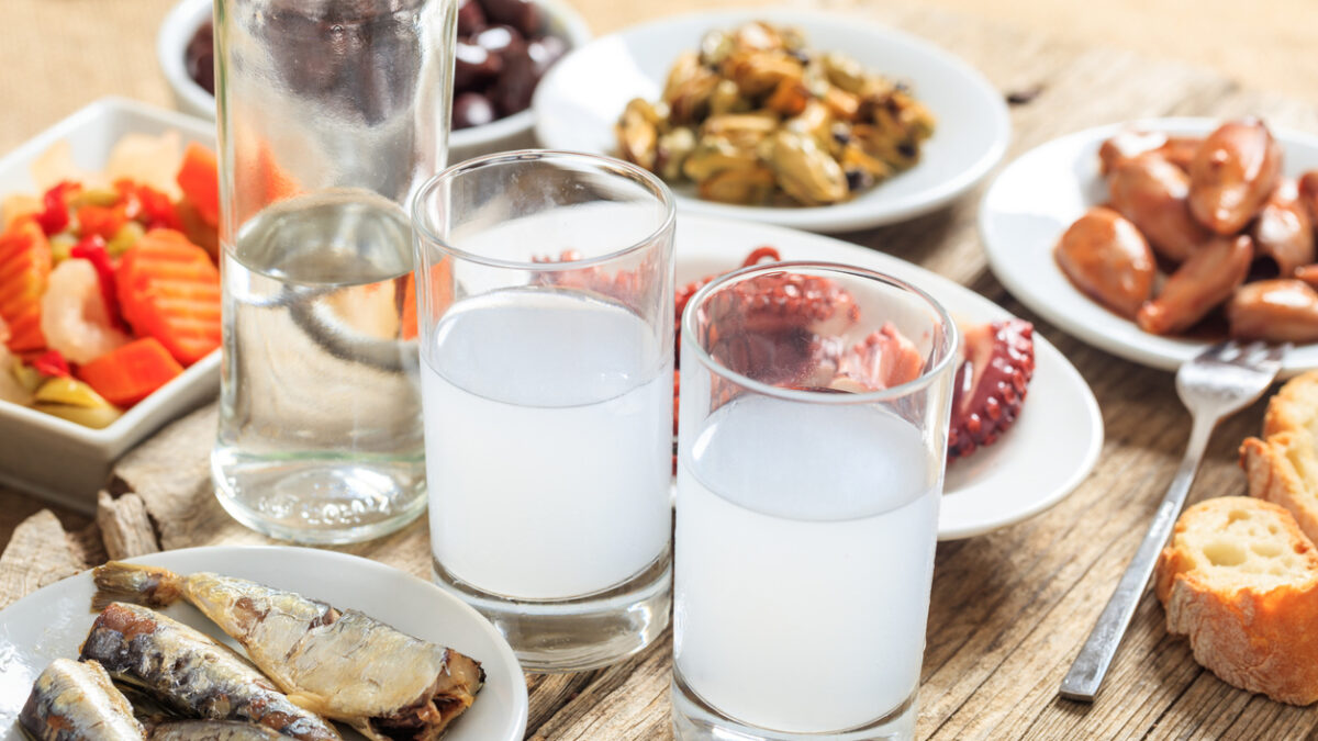 Glasses of ouzo and appetizers