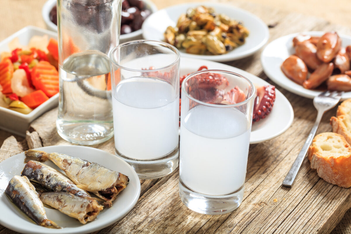 Glasses of ouzo and appetizers