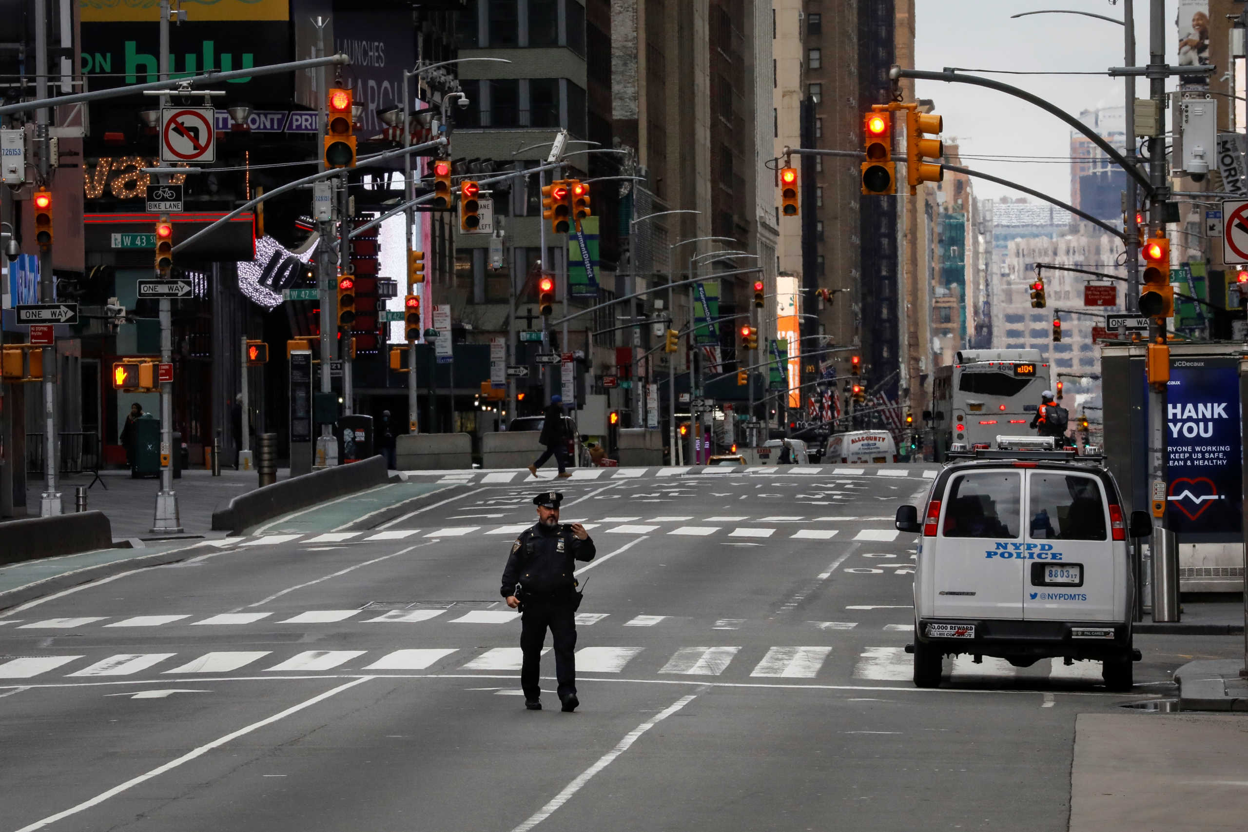 A New York City Police officer (NYPD) takes a selfie while in the middle of the street in an almost empty Times Square, during the coronavirus disease (COVID-19) outbreak, in New York City, U.S., March 31, 2020. REUTERS