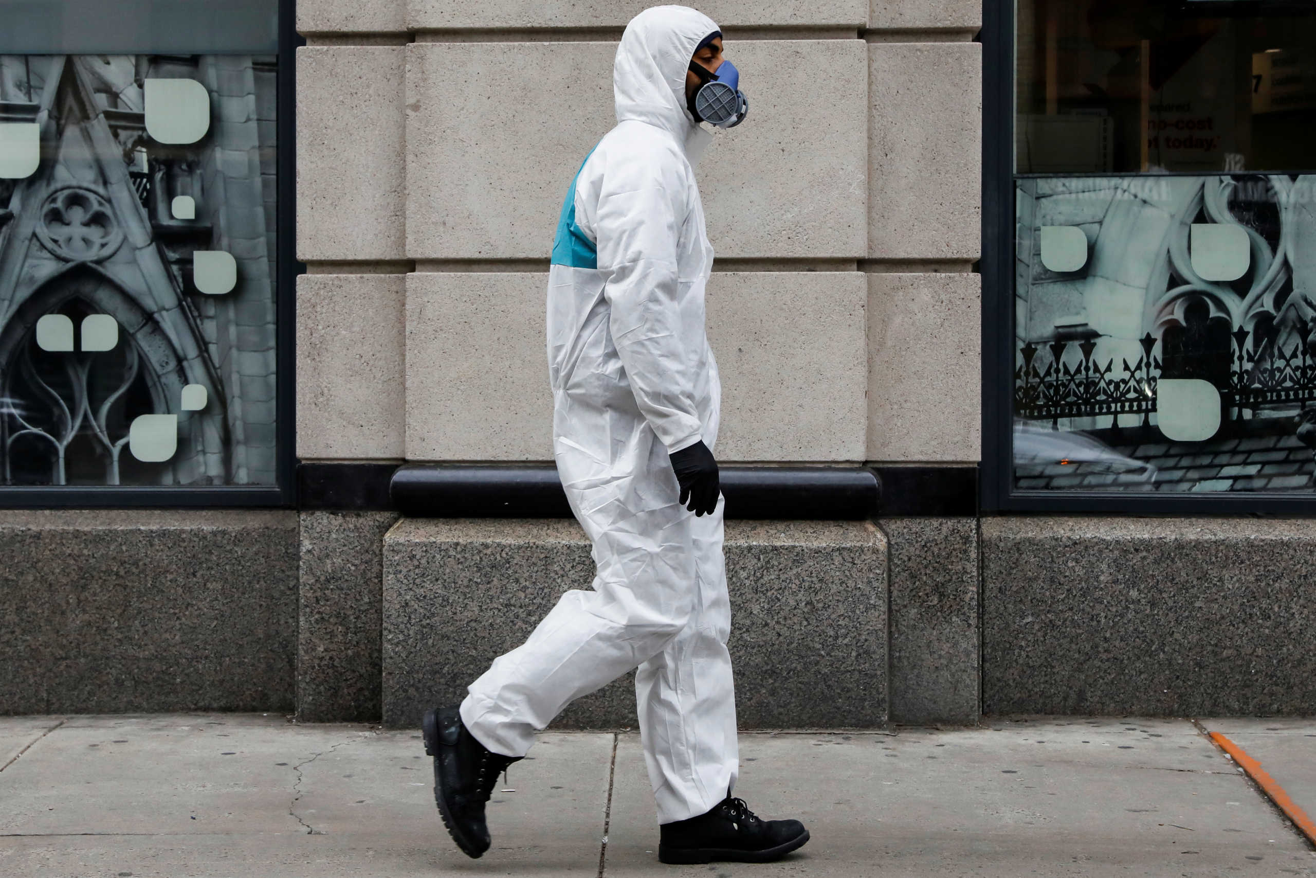 A man wears personal protective equipment (PPE) as he walks on First Avenue, during the coronavirus disease (COVID-19) outbreak, in New York City, U.S., March 31, 2020. REUTERS
