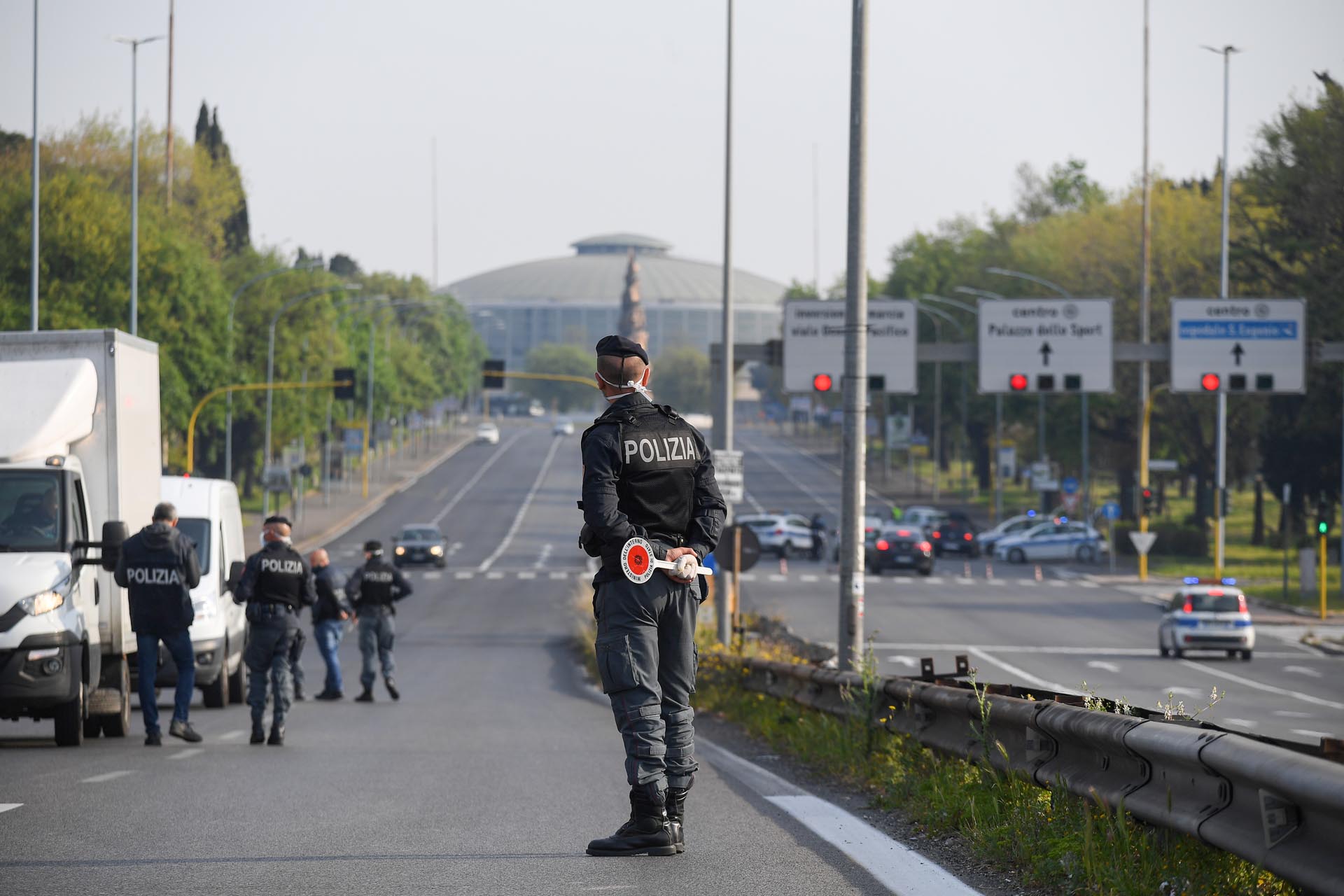 Police officers stand on the street, as they control cars during the coronavirus disease (COVID-19) outbreak, at the EUR district, in Rome, Italy April 13, 2020. REUTERS