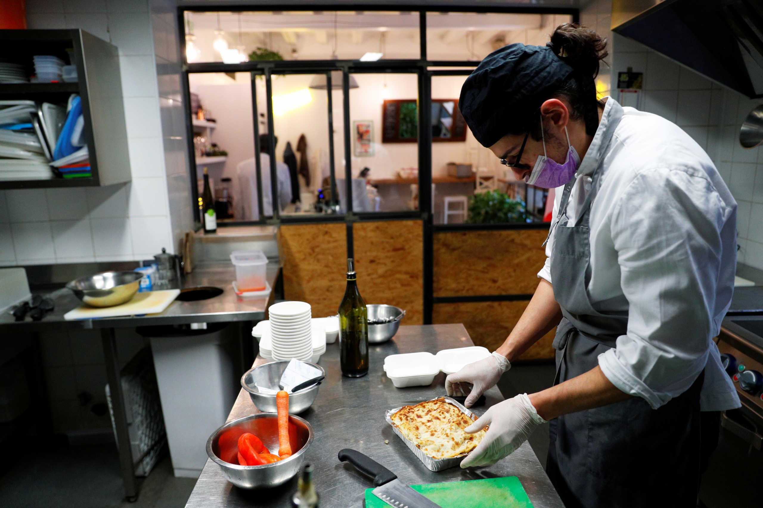 Riccardo Grieco prepares food to be delivered at Palazzo Chigi as home deliveries are the only option to keep restaurants' business running as the lockdown to prevent the spread of the coronavirus disease (COVID-19) continues in Rome, Italy, April 20, 2020. REUTERS