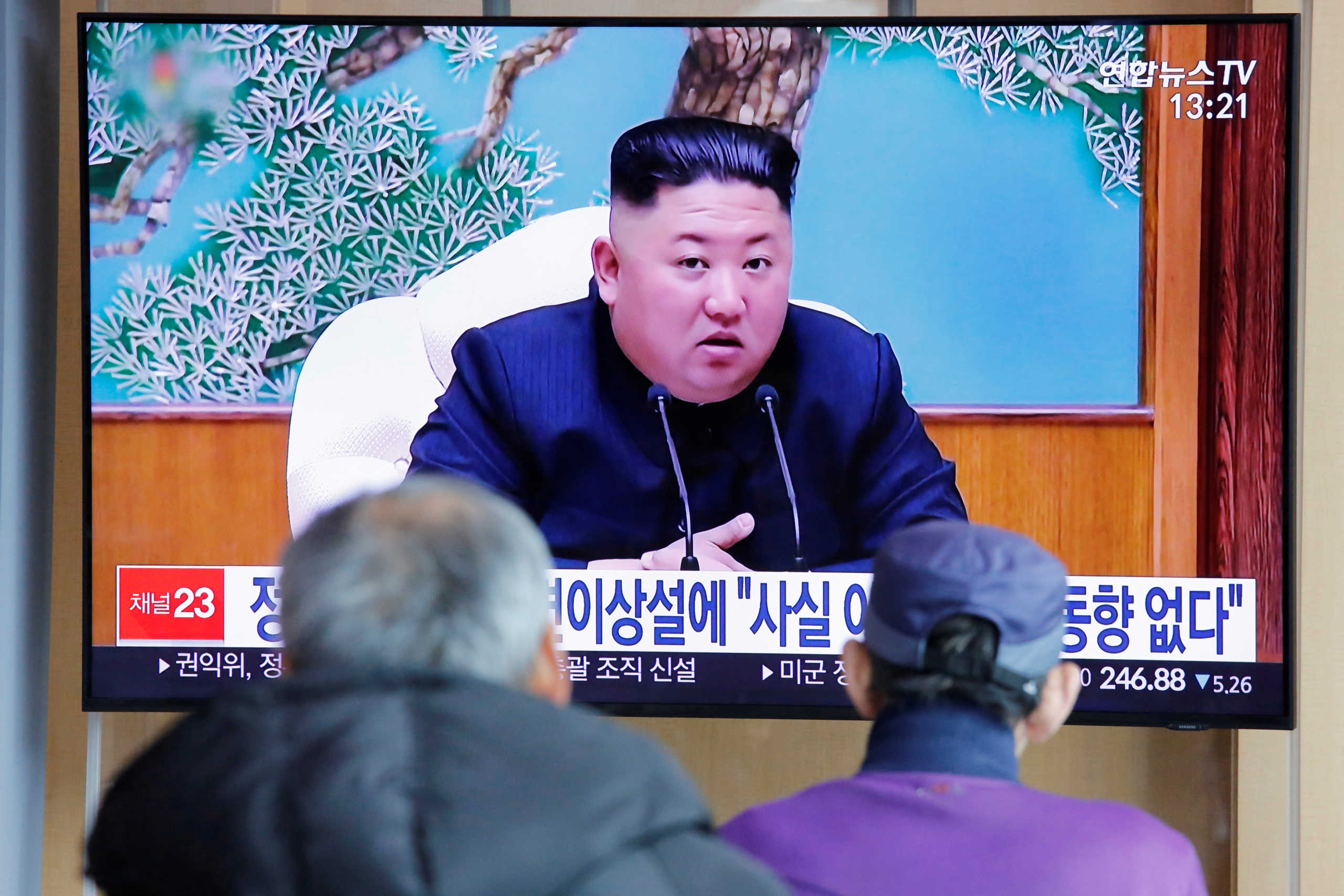 FILE PHOTO: South Korean people watch a TV broadcasting a news report on North Korean leader Kim Jong Un in Seoul, South Korea, April 21, 2020. REUTERS