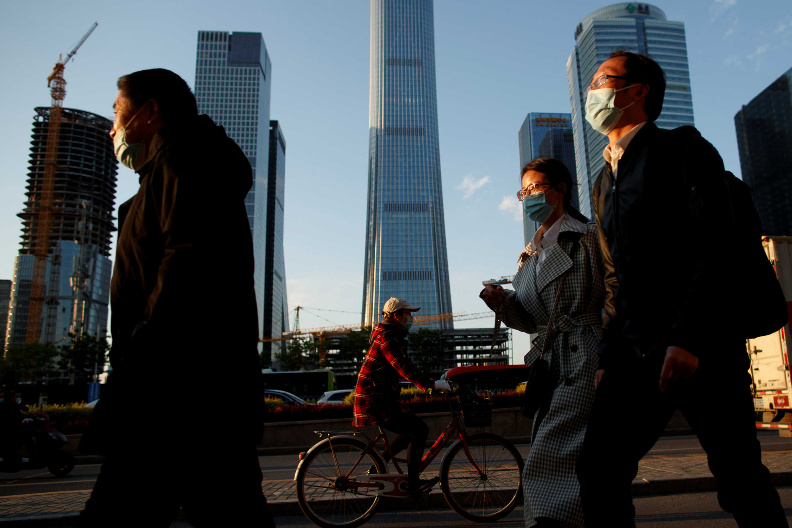 People wear protective masks as they leave work during evening rush hour in Beijing as the spread of the novel coronavirus disease (COVID-19) continues, China  April 20, 2020. REUTERS