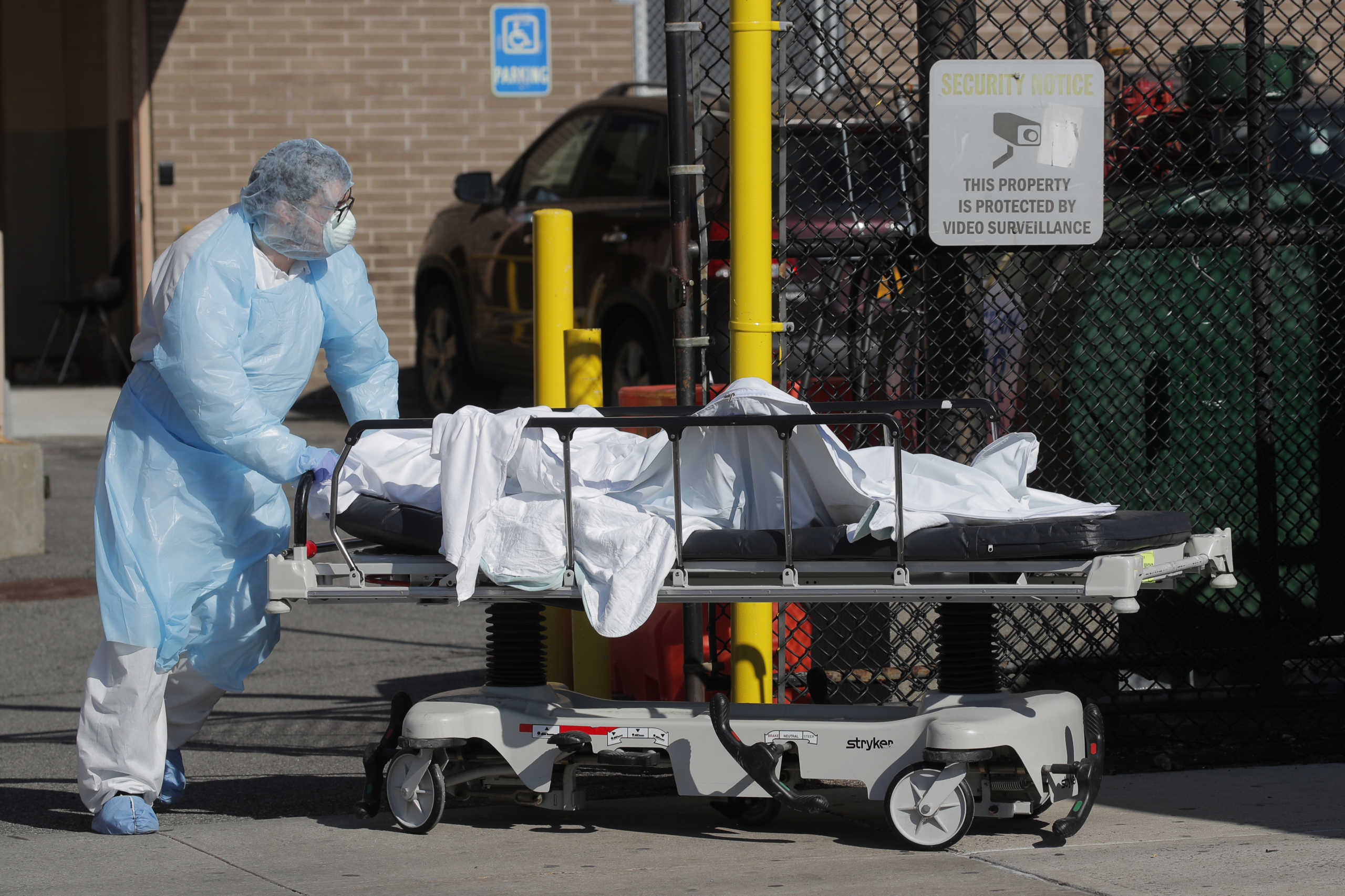 A Healthcare worker wheels the body of a deceased person into makeshift morgue outside the Wyckoff Heights Medical Center during the outbreak of the coronavirus disease (COVID-19) in the Brooklyn borough of New York City, New York, U.S., April 6, 2020. REUTERS