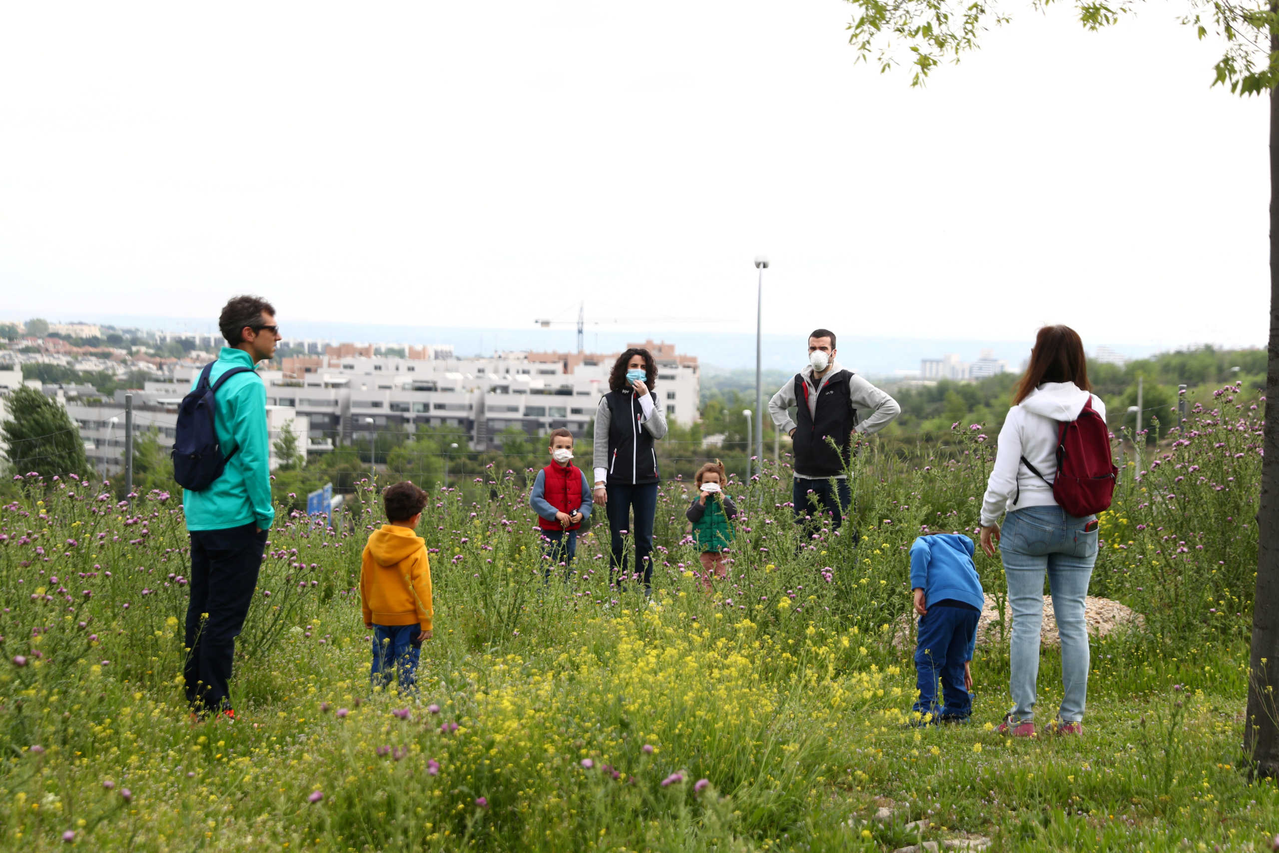 Miriam del Peso, her husband Alejandro and their children Pablo and Sofia keep social distancing as they interact with another family after restrictions were partially lifted for children for the first time in six weeks, during the coronavirus disease (COVID-19) outbreak in Madrid, Spain, April 26, 2020. REUTERS
