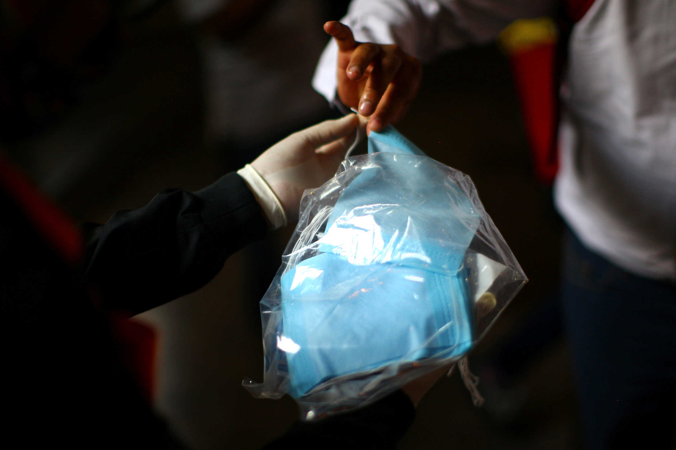 A passenger receives a mask for mandatory use from next Friday onwards, inside any subway station, as a measure to contain the spread of the coronavirus disease (COVID-19), in Mexico City, Mexico April 15, 2020.  REUTERS