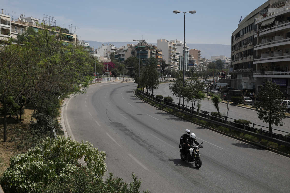 Police officers ride a motorcycle on an empty avenue on Easter Sunday, during a nationwide lockdown to prevent the spread of the coronavirus disease (COVID-19) outbreak in Athens, Greece, April 19, 2020. REUTERS