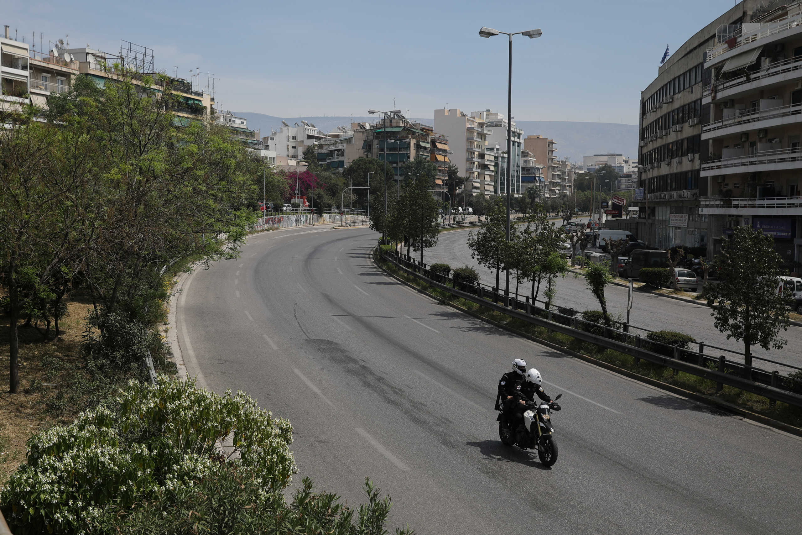 Police officers ride a motorcycle on an empty avenue on Easter Sunday, during a nationwide lockdown to prevent the spread of the coronavirus disease (COVID-19) outbreak in Athens, Greece, April 19, 2020. REUTERS