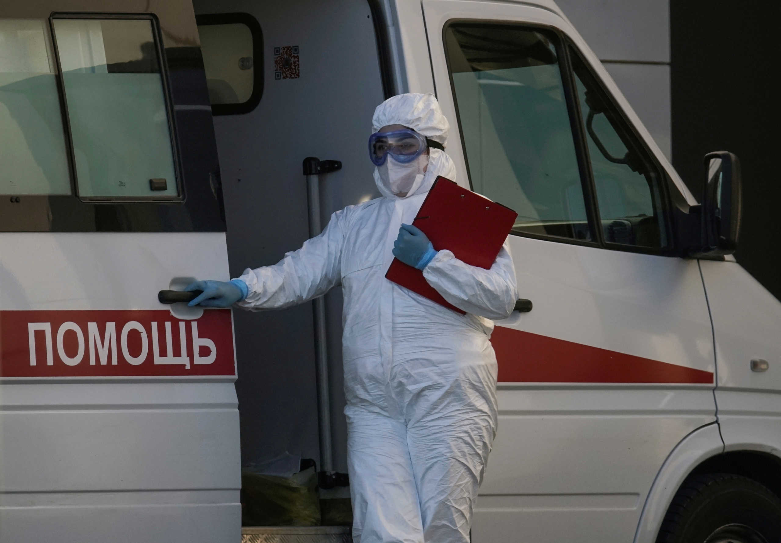 A medical specialist wearing protective gear stands near an ambulance outside a hospital for patients infected with the coronavirus disease (COVID-19) on the outskirts of Moscow, Russia April 12, 2020. REUTERS