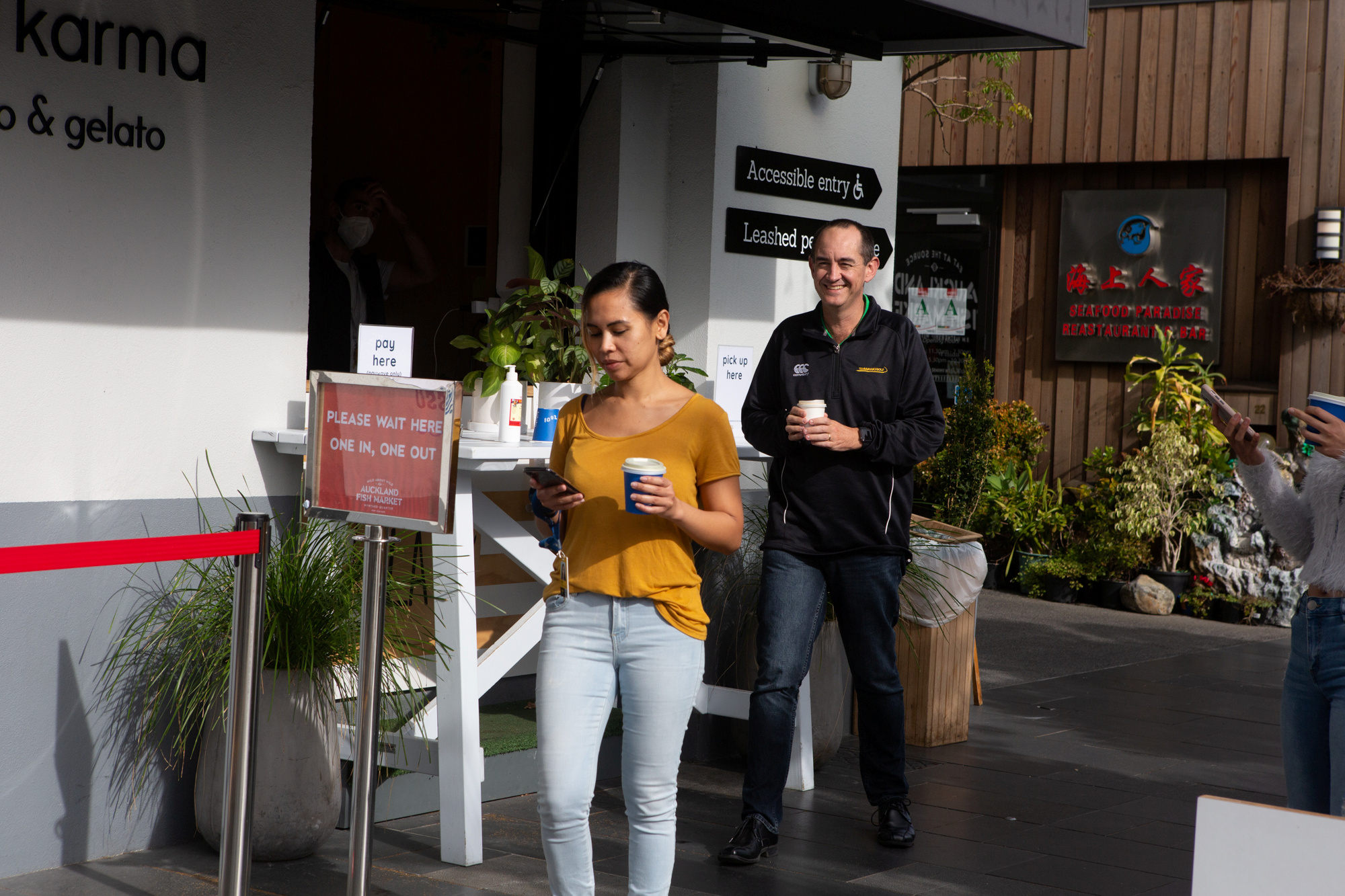 People collect takeaway food at a cafe as New Zealand eases strict regulations implemented to curb the spread of the coronavirus disease (COVID-19) in Auckland, New Zealand, April 28, 2020.  REUTERS