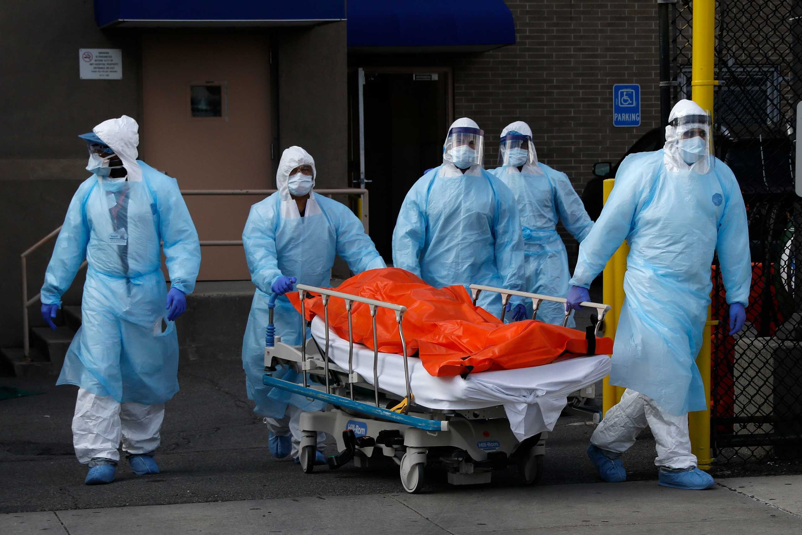 Healthcare workers wheel the body of deceased person from the Wyckoff Heights Medical Center during the outbreak of the coronavirus disease (COVID-19) in the Brooklyn borough of New York City, New York, U.S., April 2, 2020. REUTERS
