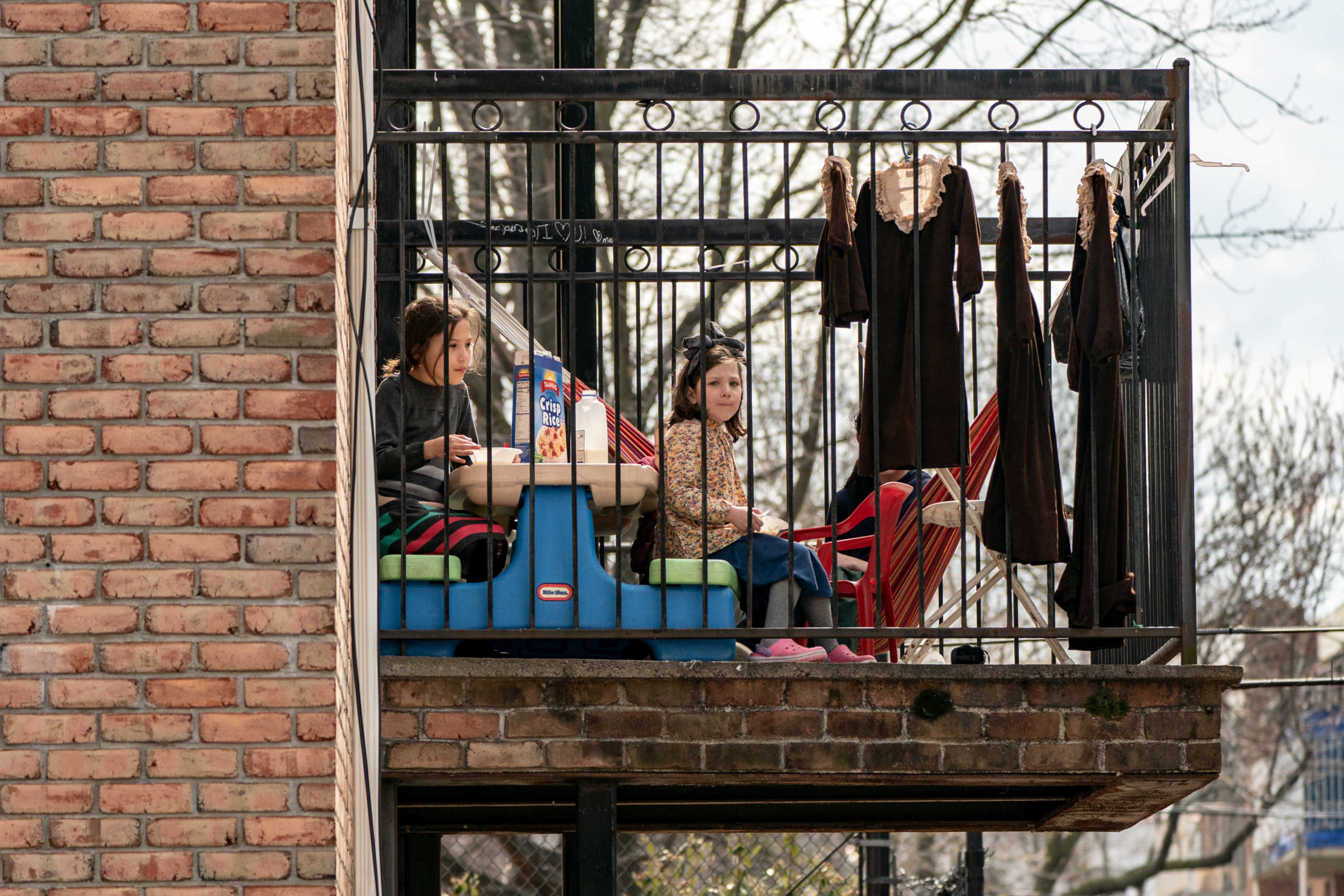 Children have a meal at the balcony during the outbreak of the coronavirus disease (COVID-19) in New York City, U.S., April 5, 2020. REUTERS