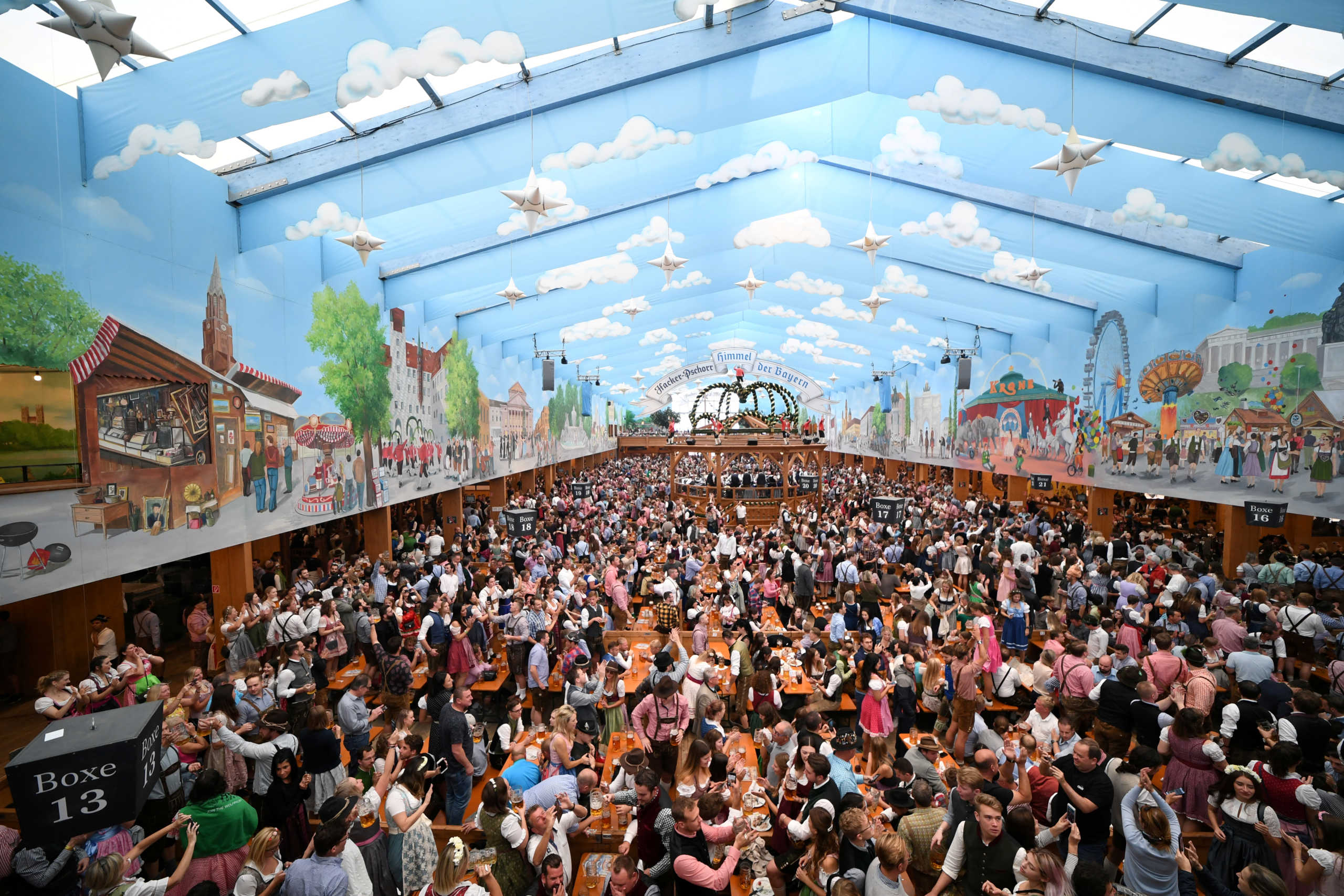 FILE PHOTO: People dressed in traditional clothes sit inside a beer tent after the Oktoberfest parade in Munich, Germany, September 22, 2019. REUTERS