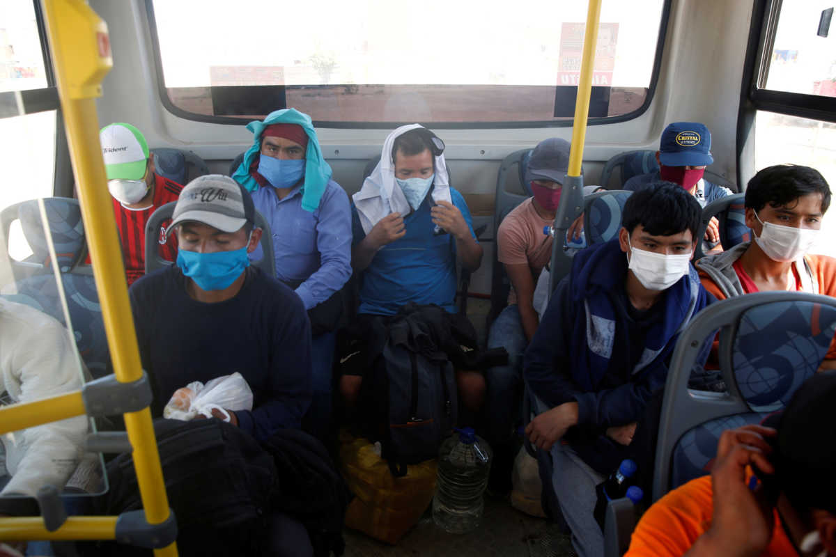 Peruvians who were stranded in Lima wait for the start of a bus ride out of the city amid the spread of the coronavirus disease (COVID-19), in Lima, Peru April 21, 2020. Picture taken April 21, 2020. REUTERS