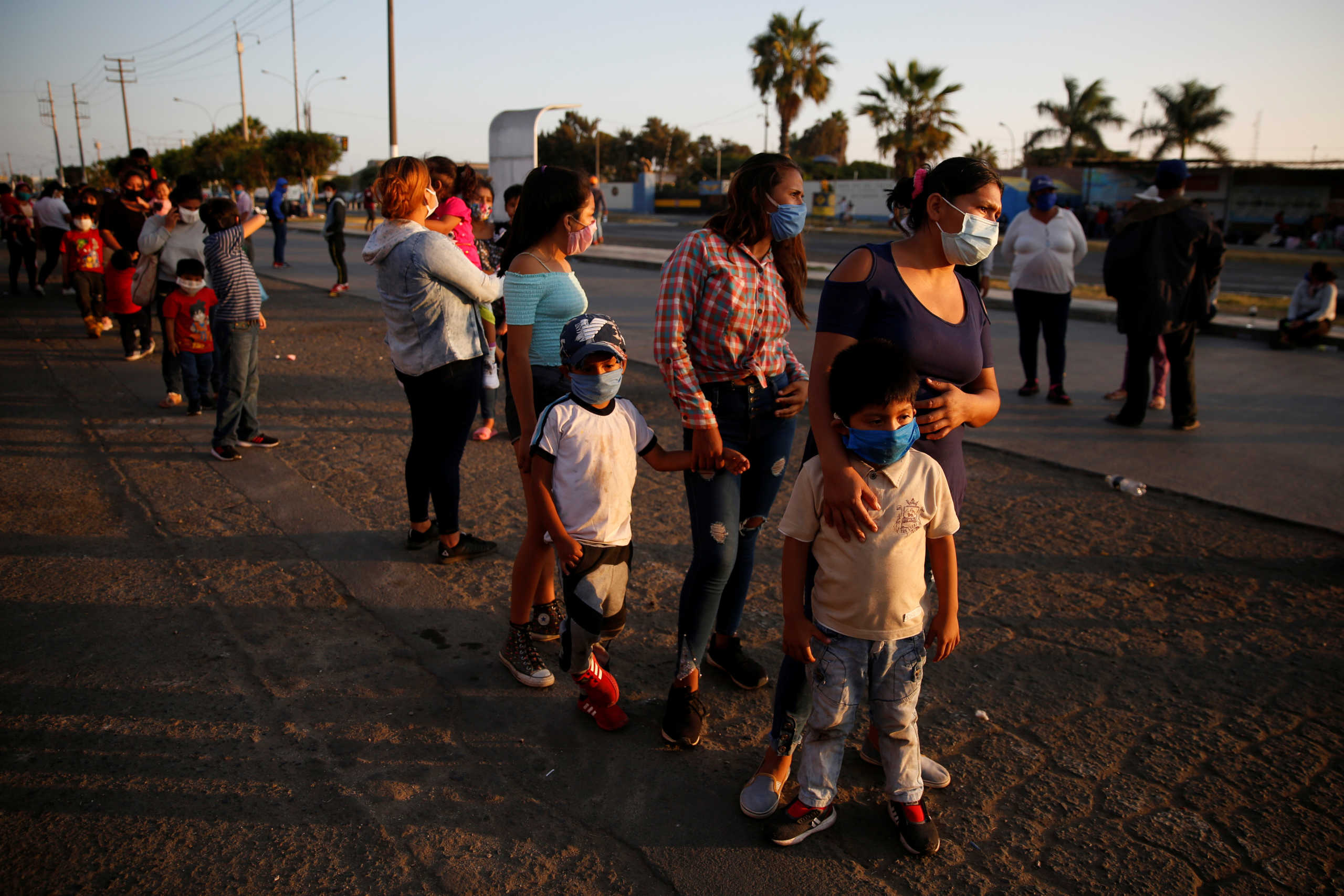 People are seen outside of a Peruvian Air Force base while waiting for flights home to the Peruvian Amazon amid the spread of the coronavirus disease (COVID-19), in Lima, Peru April 24, 2020. REUTERS