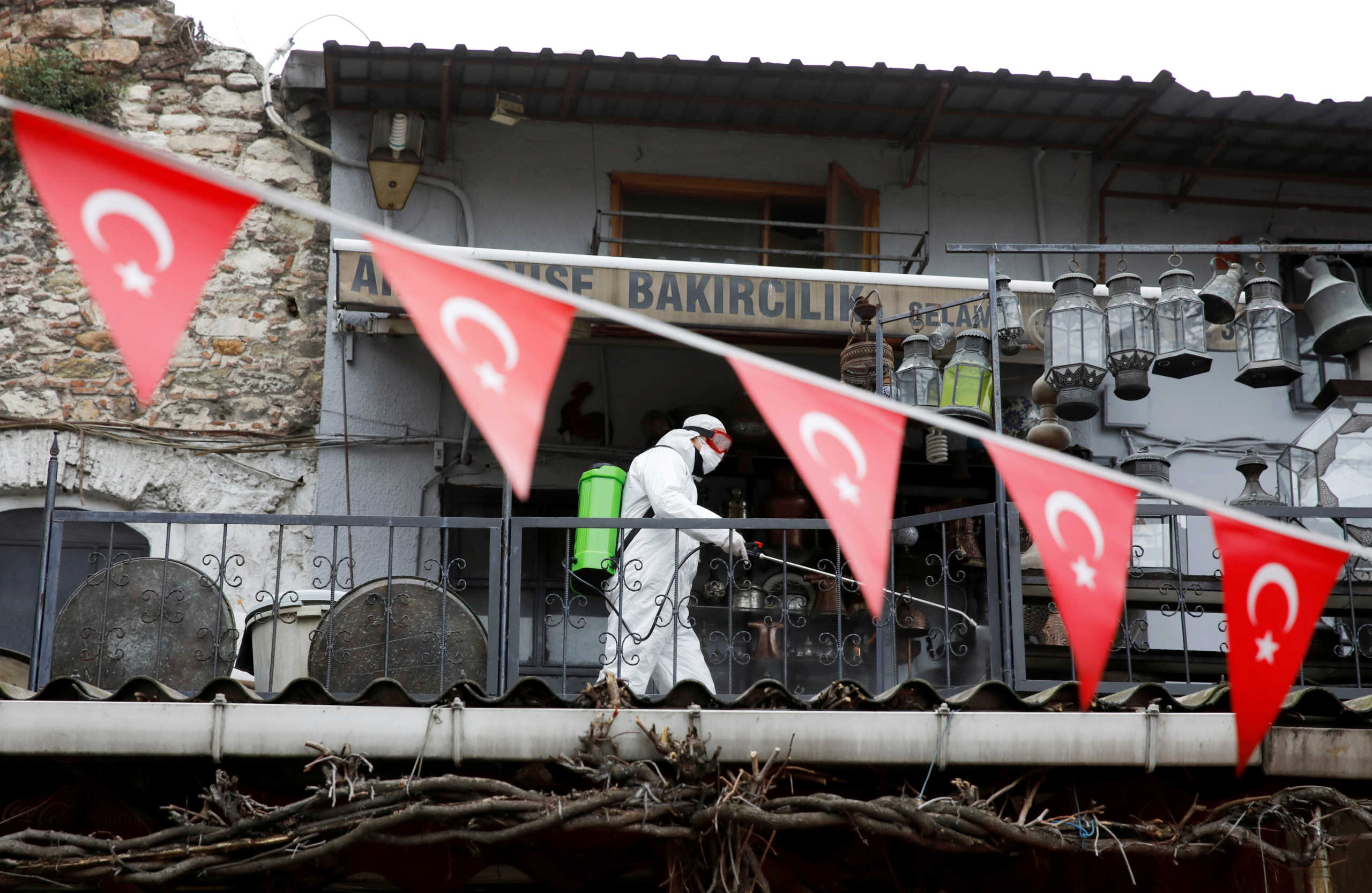 FILE PHOTO: A worker in a protective suit sprays disinfectant at Grand Bazaar, known as the Covered Bazaar, to prevent the spread of coronavirus disease (COVID-19), in Istanbul, Turkey, March 25, 2020. REUTERS