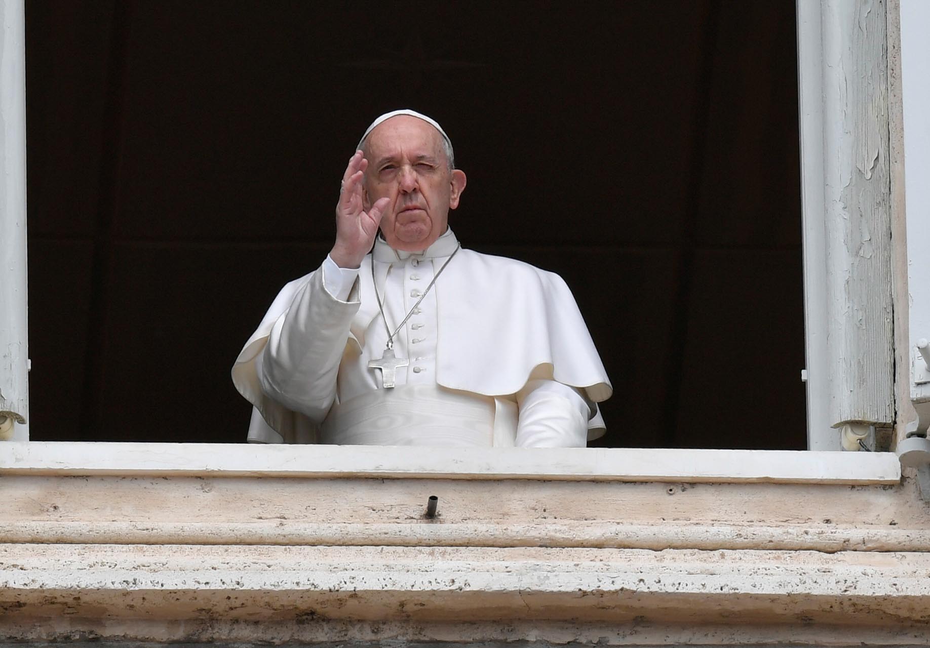 Pope Francis waves from the window of the Apostolic Palace on Easter Monday at the Vatican April 13, 2020.  Vatican Media