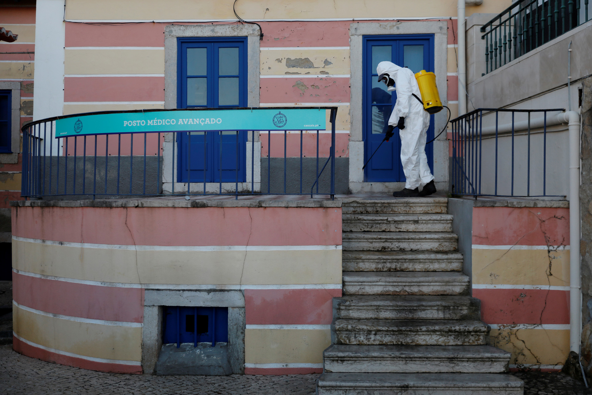 FILE PHOTO: Municipal worker disinfects streets at downtown Cascais, to stop the spread of coronavirus disease (COVID-19) in Cascais, Portugal March 28, 2020. REUTERS