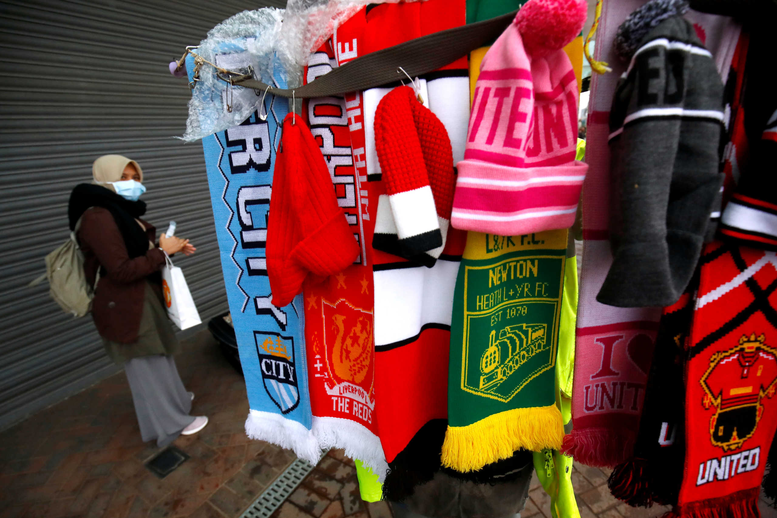 Premier League - Coronavirus impact on the Premier League - Old Trafford, Manchester, Britain - March 14, 2020   General view of scarves and hats for sale outside Old Trafford as the Premier League is suspended due to the number of coronavirus cases growing around the world   Action Images via Reuters
