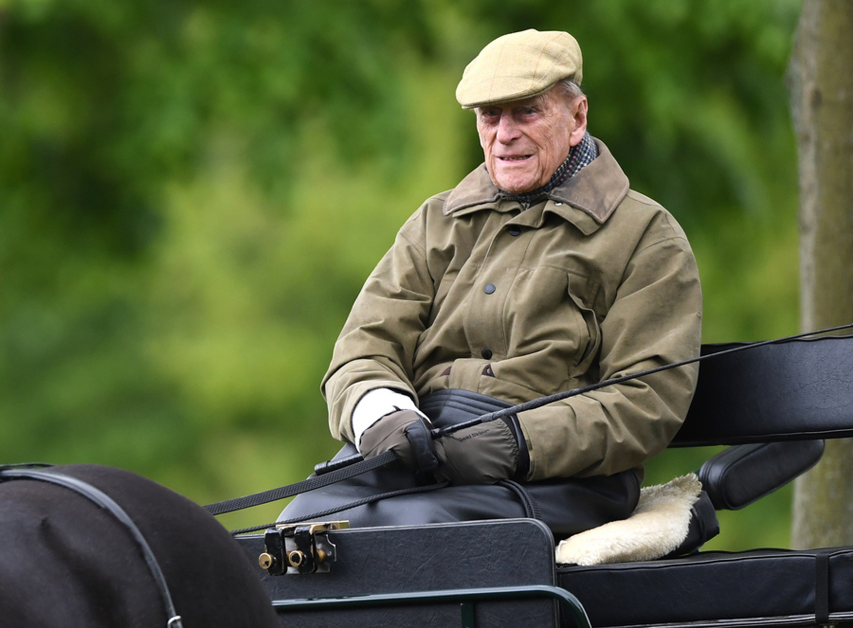 epa07557436 Britain's Prince Philip, the Duke of Edinburgh sits on a carriage during the Royal Windsor Horse Show, in Windsor, Britain, 09 May 2019. The event is the United Kingdom's largest outdoor horse show with international competitions in three different equestrian disciplines.  EPA