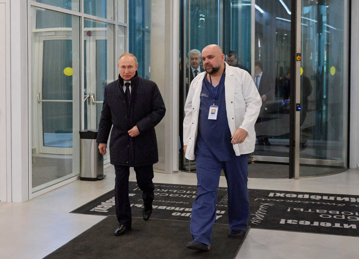 Russian President Vladimir Putin listens to Denis Protsenko, chief physician of a hospital for patients infected with coronavirus disease (COVID-19), during a tour of the hospital on the outskirts of Moscow, Russia March 24, 2020. Picture taken March 24, 2020. Sputnik