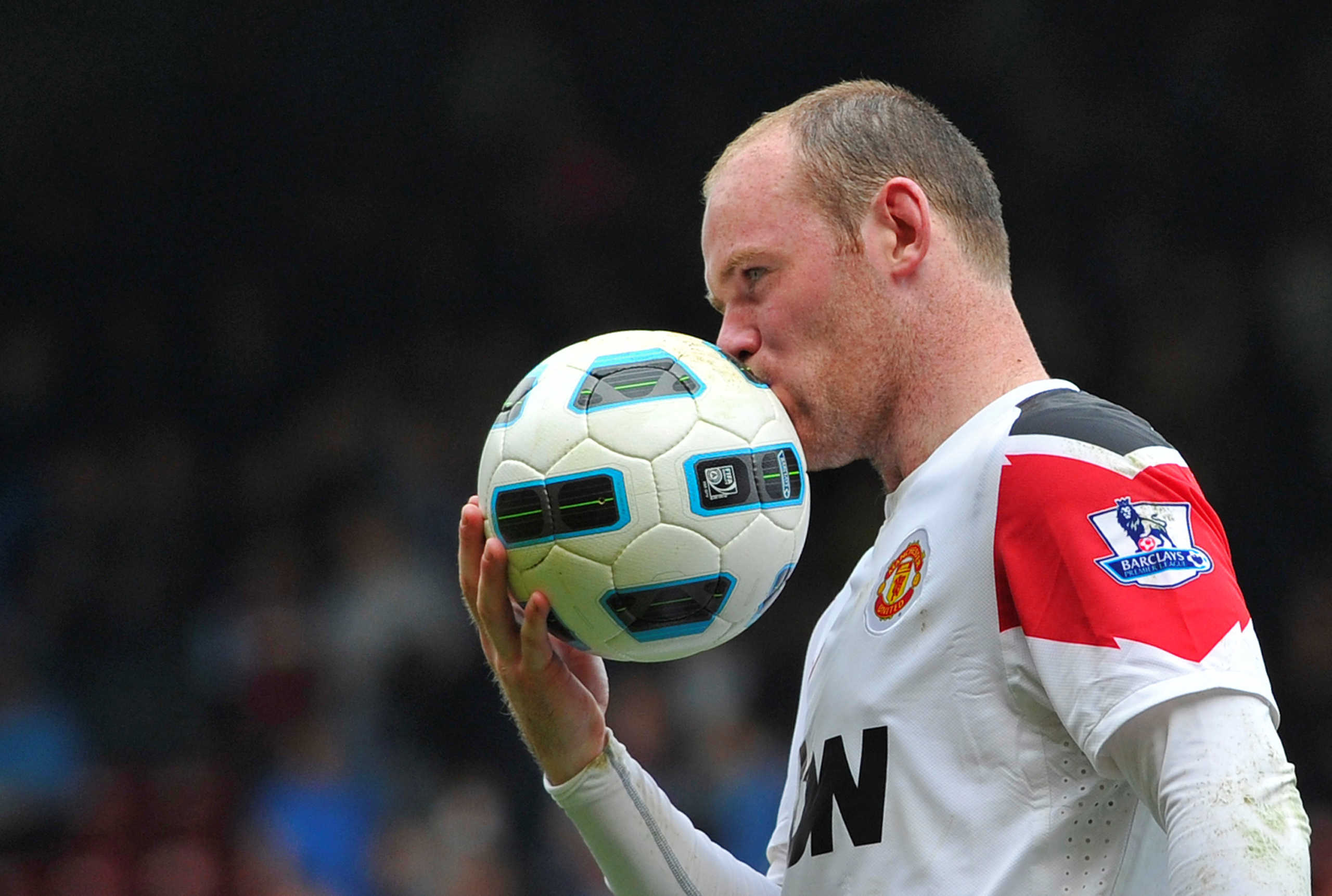 FILE PHOTO: ON THIS DAY -- April 2 April 2, 2011     SOCCER - Manchester United striker Wayne Rooney kisses the ball after scoring a hat-trick in a 4-2 Premier League victory over West Ham United at Upton Park.     Rooney swore into a pitchside camera after scoring his third goal. He was later suspended by the Football Association for two matches and missed United's FA Cup semi-final with Manchester City as a result.     United were beaten by City in the FA Cup game but went on to win the league that season for the 19th time, moving one ahead of Liverpool in the list of all-time English top-flight titles. REUTERS