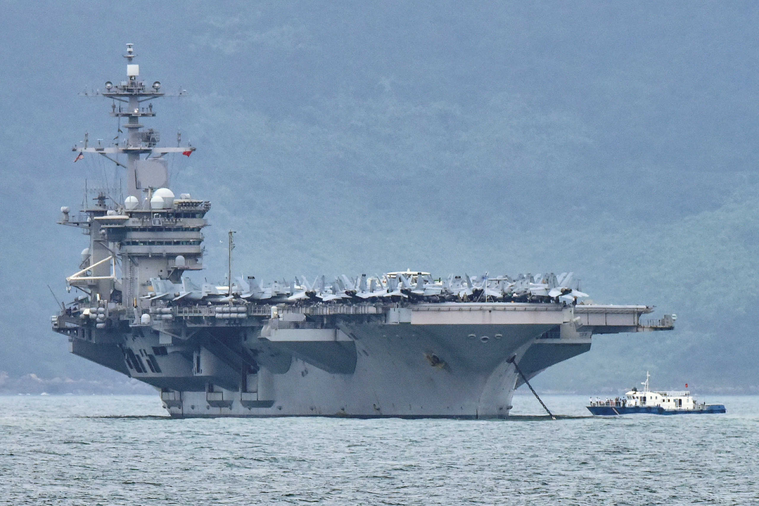 FILE PHOTO: The aircraft carrier Theodore Roosevelt (CVN-71) is pictured as it enters the port in Da Nang, Vietnam, March 5, 2020. REUTERS