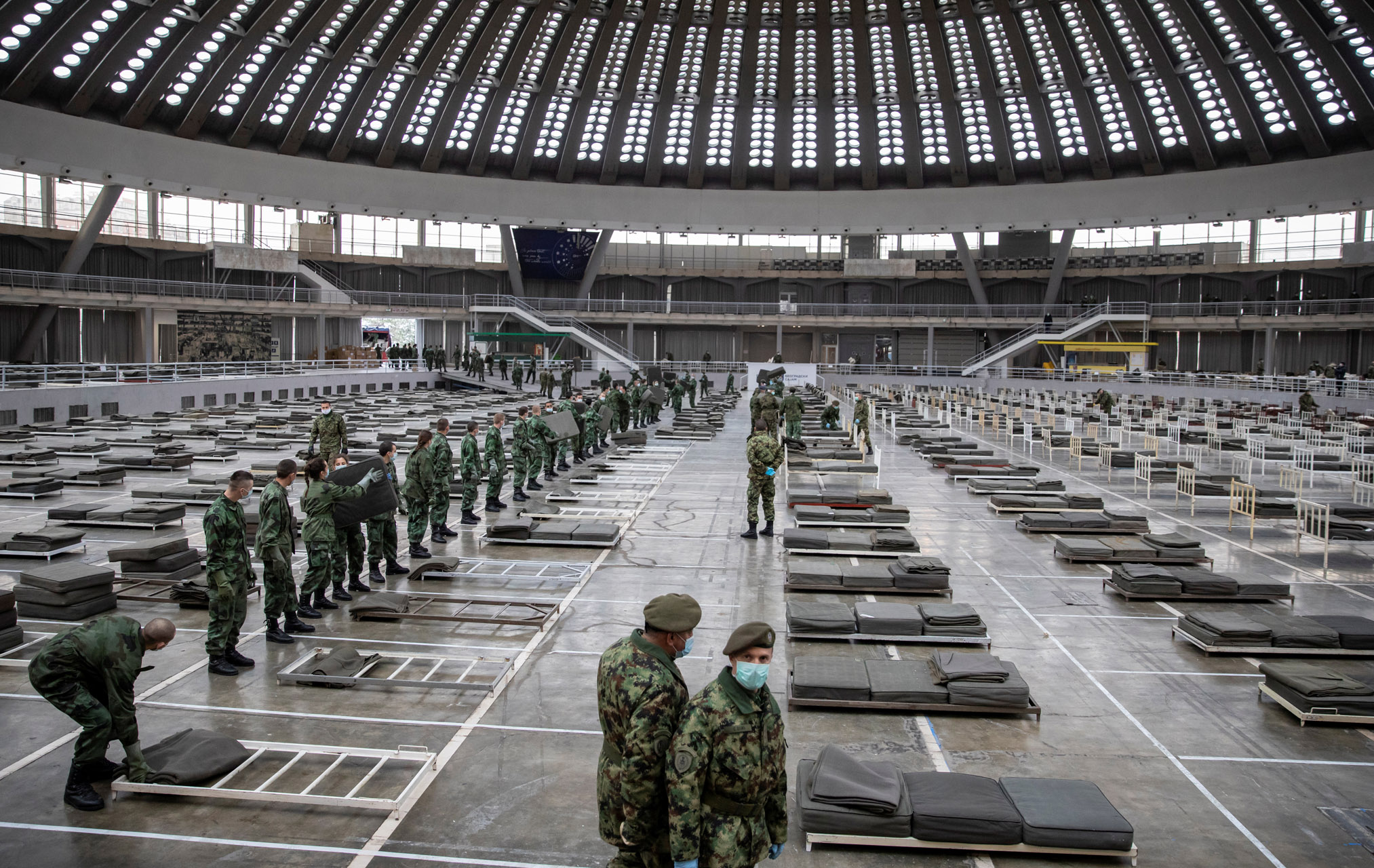 Serbian military sets up the beds inside Hall 1 of the Belgrade Fair to accommodate people who suffer mild symptoms of coronavirus disease (COVID-19) in Belgrade, Serbia, March 24, 2020. REUTERS