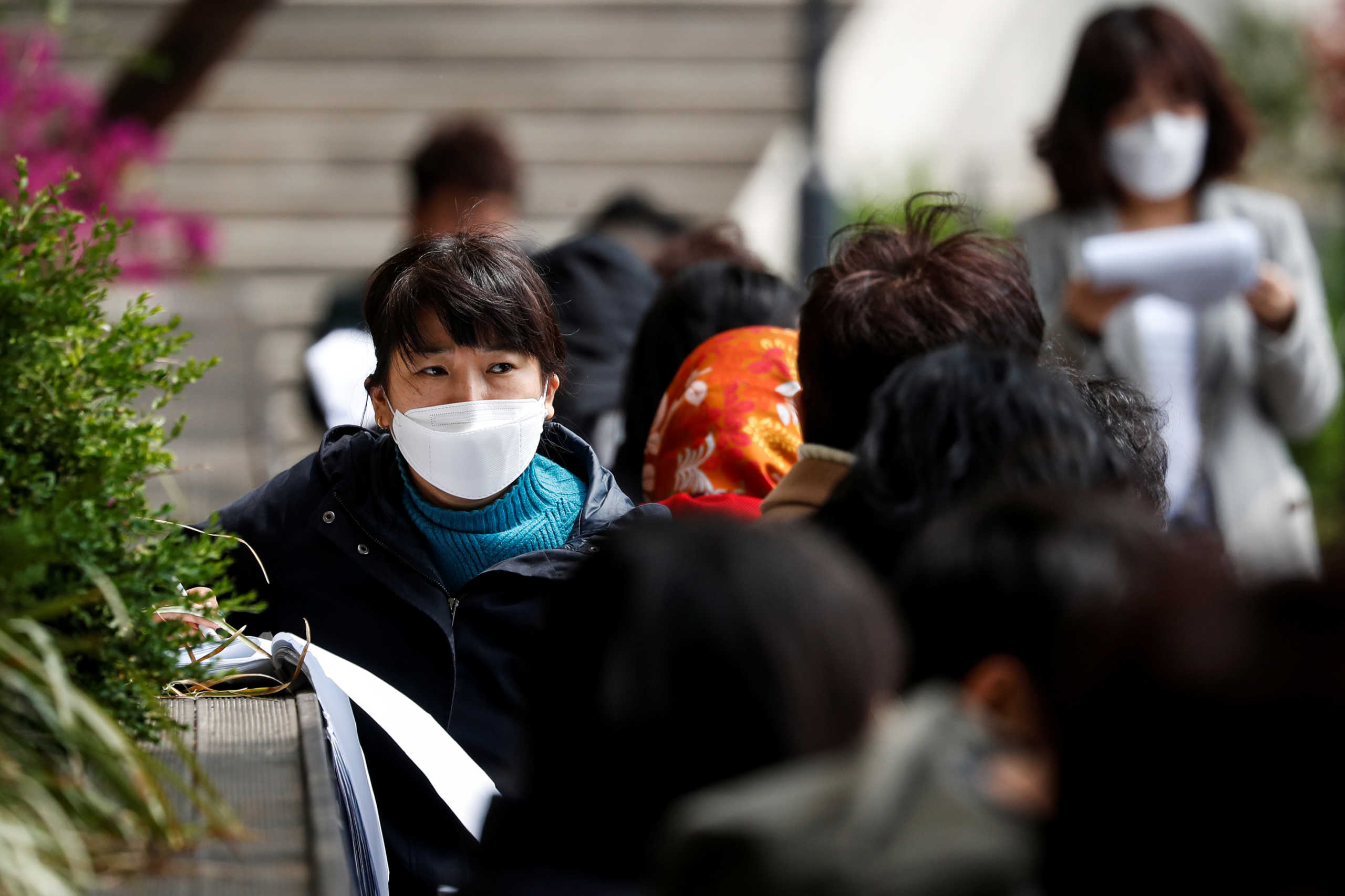 A South Korean job seekers wearing a face mask looks on while preparing before an exam conducted outdoors to avoid the spread of the coronavirus disease (COVID-19), in Seoul, South Korea, April 25, 2020. REUTERS