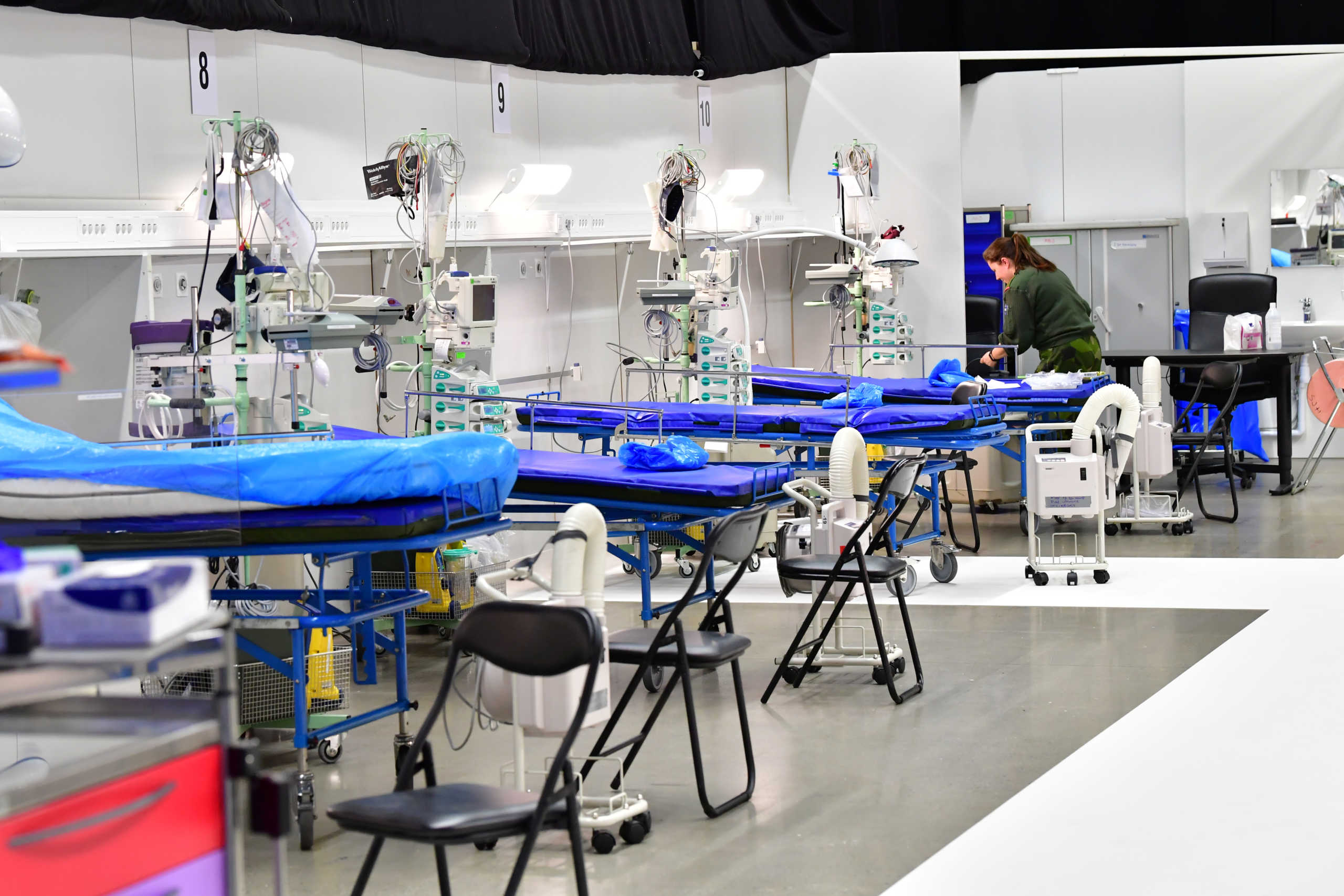 A member of military personnel works to prepare a field hospital which will provide extra intensive care space for patients with coronavirus disease (COVID-19), inside the exhibition centre Stockholmsmassan in Alvsjo, Stockholm, Sweden March 30, 2020. Jonas Ekstromer