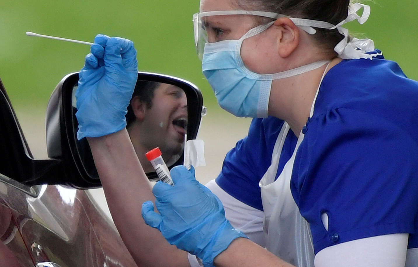 FILE PHOTO: Medical staff are seen testing people at a coronavirus test centre in the car park of Chessington World of Adventures as the spread of the coronavirus disease (COVID-19) continues, Chessington, Britain, April 2, 2020.   To match Special Report HEALTH-CORONAVIRUS