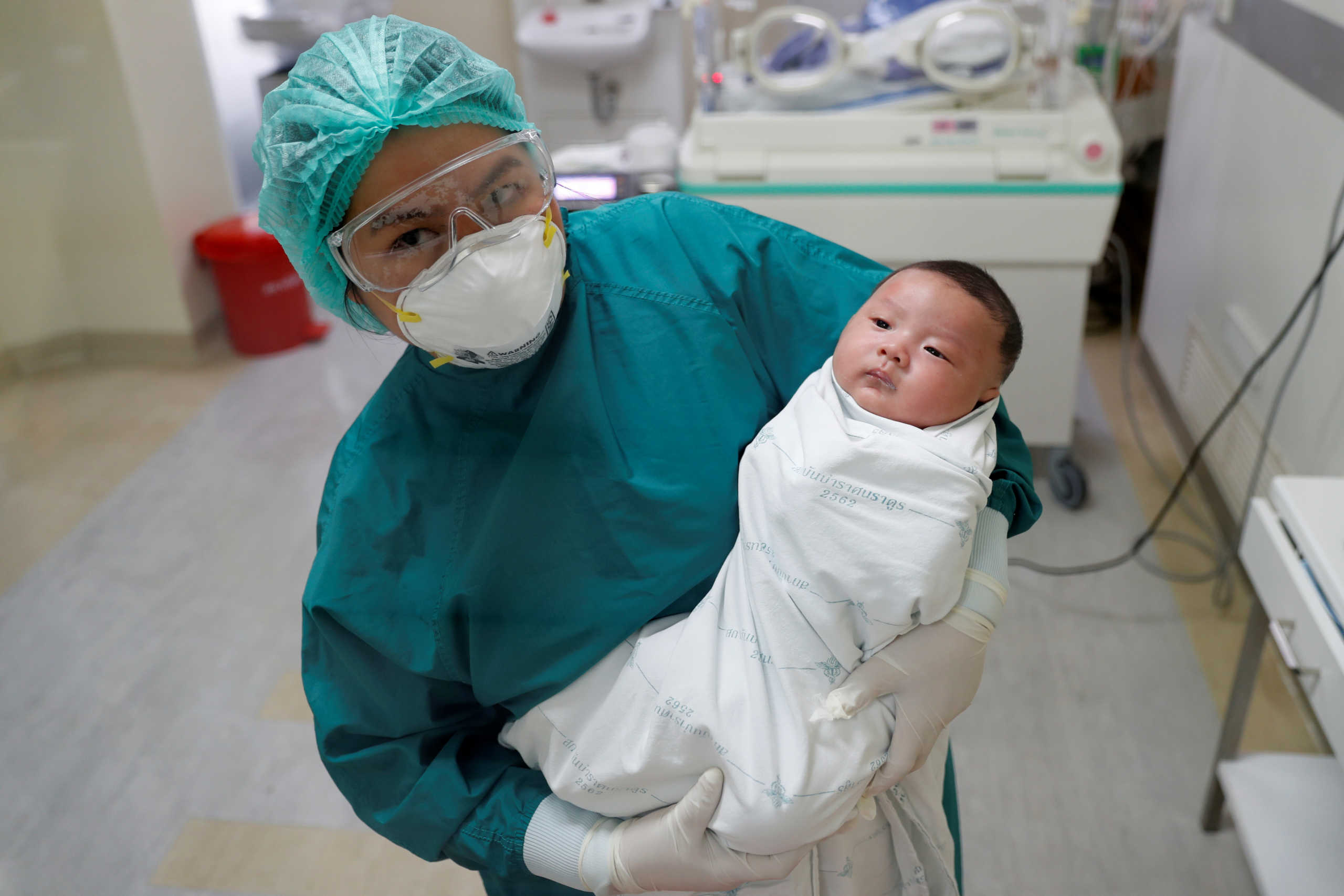 A nurse poses for a picture with a one-month-old Thai baby, the country's youngest coronavirus disease (COVID-19) patient that has successfully recovered, a day before being discharged from Bamrasnaradura Infectious Diseases Institute in Bangkok, Thailand April 22, 2020. REUTERS