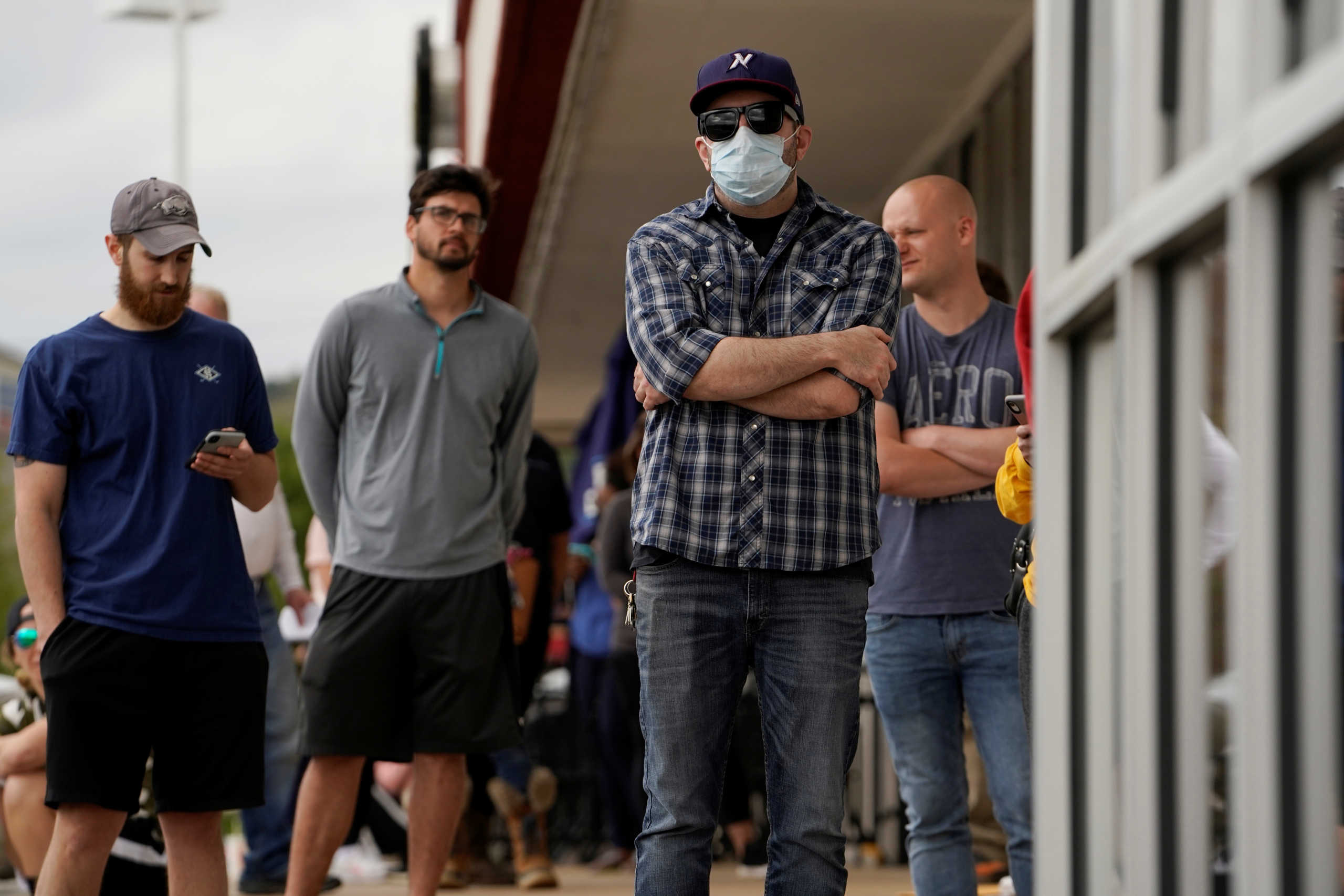 People who lost their jobs wait in line to file for unemployment following an outbreak of the coronavirus disease (COVID-19), at an Arkansas Workforce Center in Fayetteville, Arkansas, U.S. April 6, 2020. REUTERS